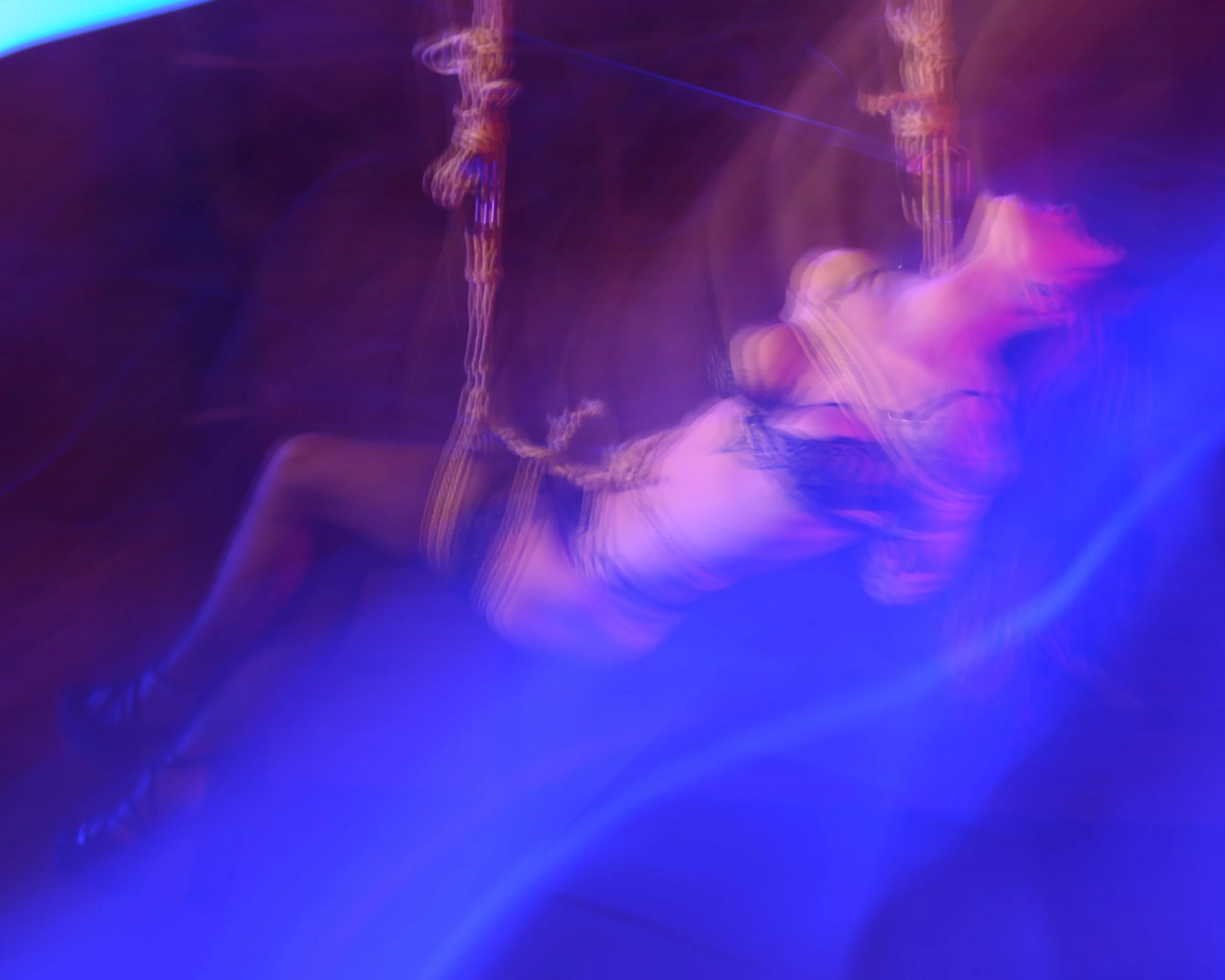 Artistic red and blue image of model in suspension