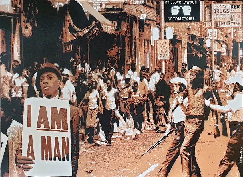 Contemporary stencil artwork depicting a man holding an "I AM A MAN" protest sign in front of a Civil Rights demonstration, rendered in a limited brown and cream color palette.