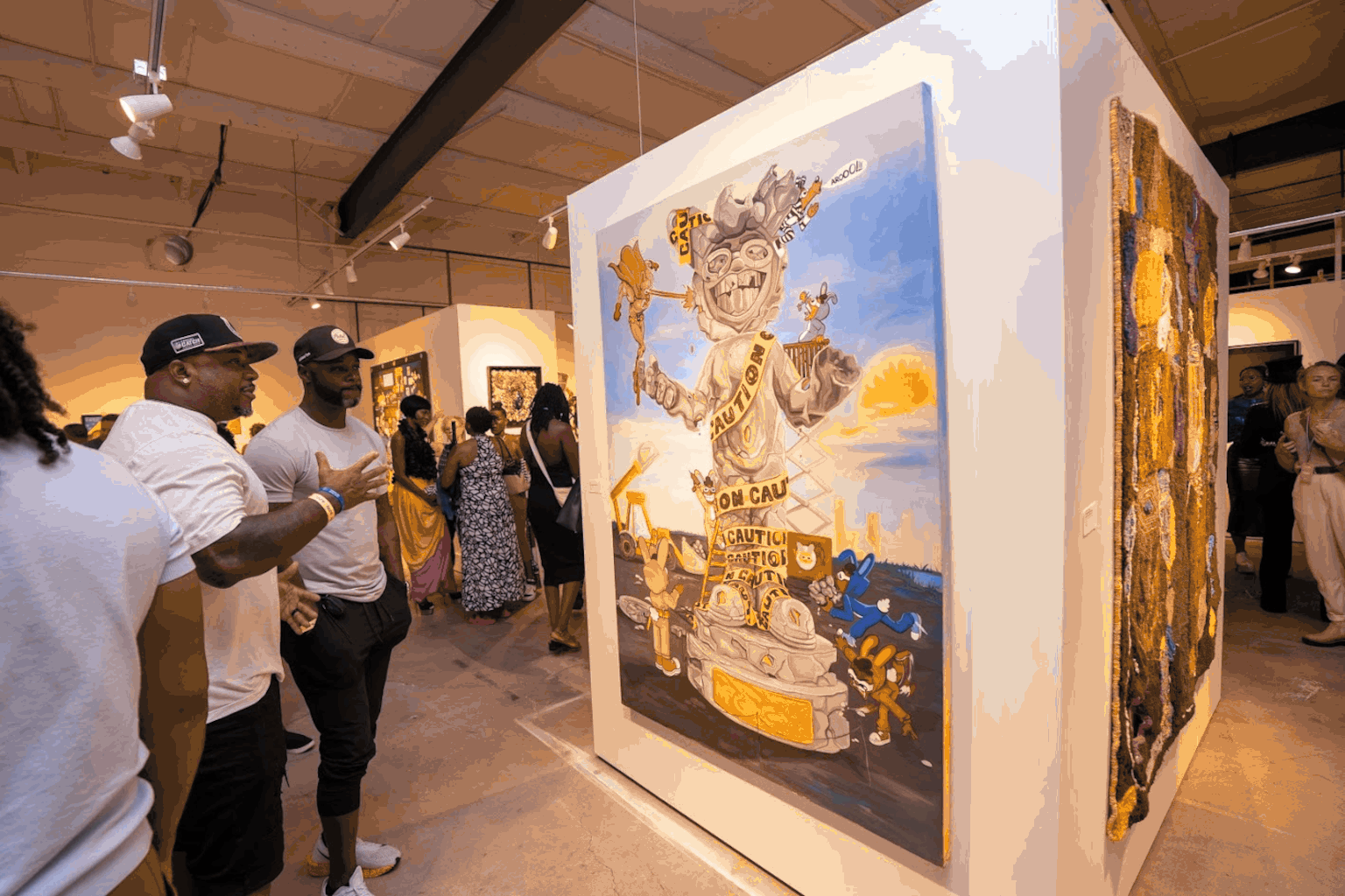 Visitors viewing and discussing contemporary artwork at BUTTER Fine Art Fair in Indianapolis.