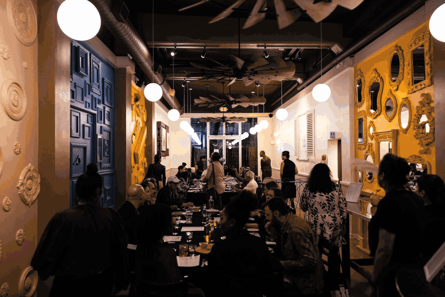 Guests gathered around tables in an art-filled space during Nexus: SF/Bay Area Black Art Week.
