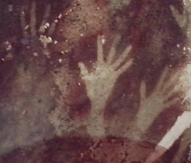 Prehistoric hand stencils painted on cave wall in Sulawesi Indonesia