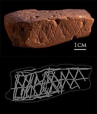 Ochre stone engraved with geometric cross-hatched patterns from Blombos Cave in South Africa