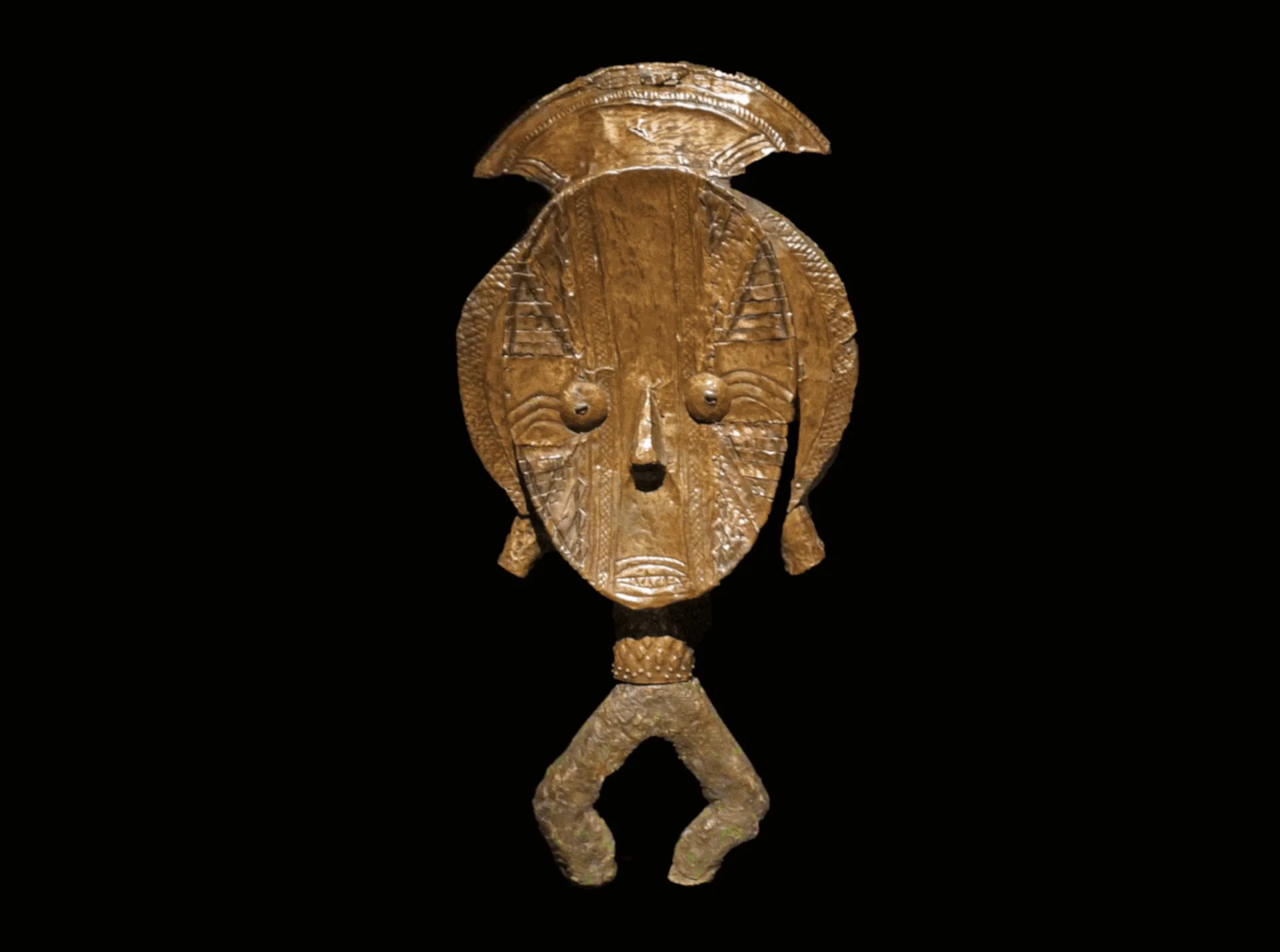 Obamba reliquary guardian figure from Gabon with stylized geometric facial features against a black background.