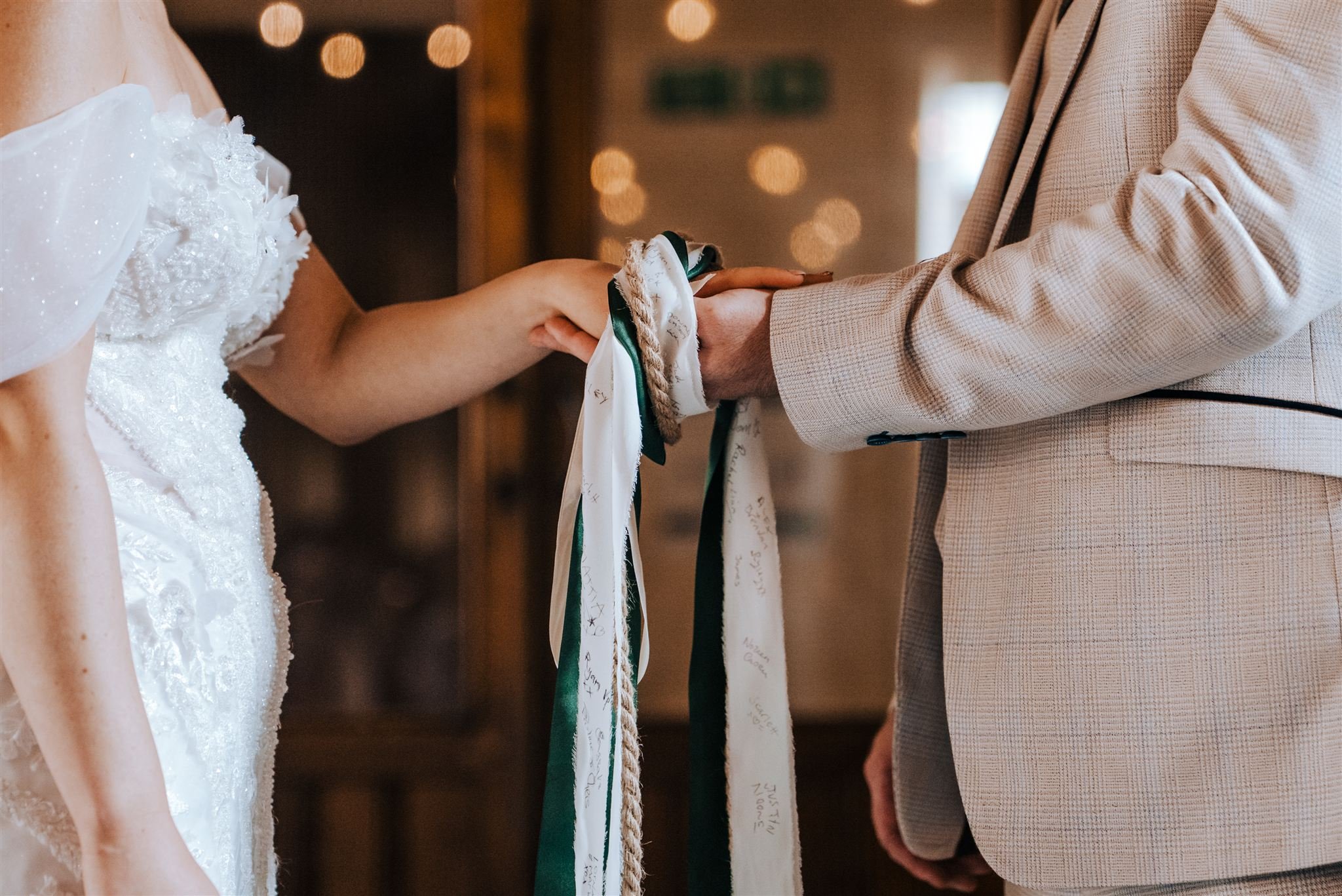 Hand fasting with ribbons of personalised messages from guests.jpg