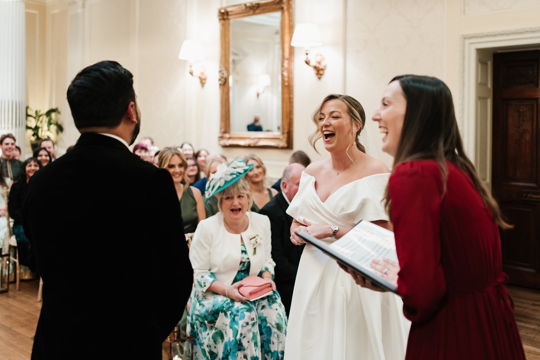 Celebrant laughing with bride and mum in ceremony