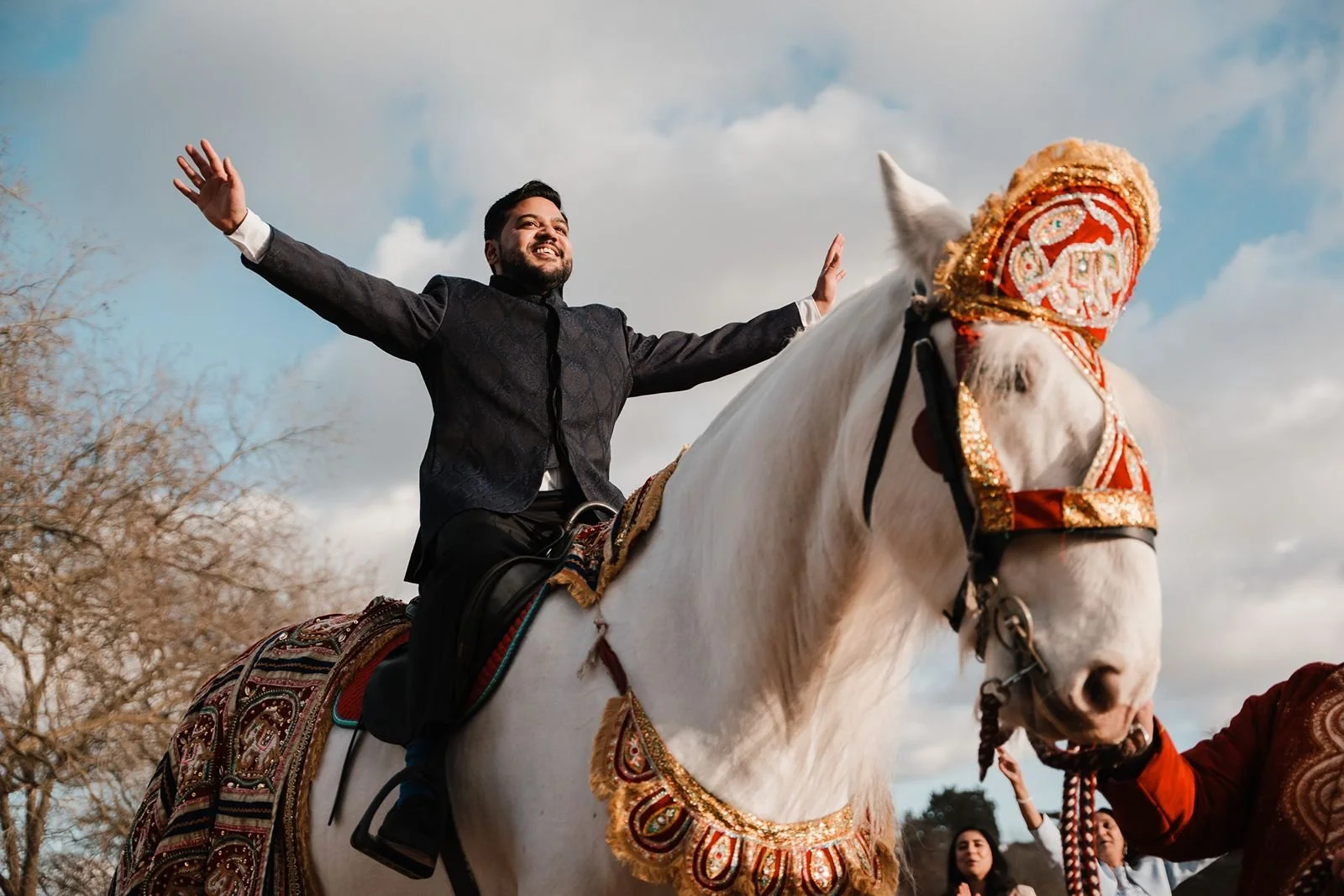 Groom arriving at Hedsor House wedding venue on white horse