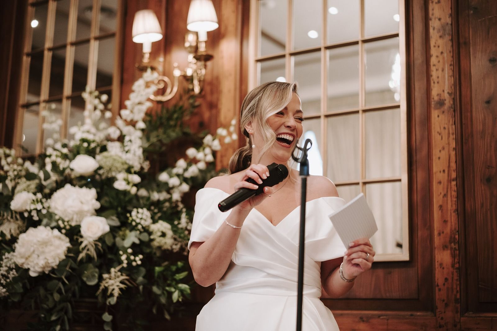 Bride with microphone smiling giving a speech