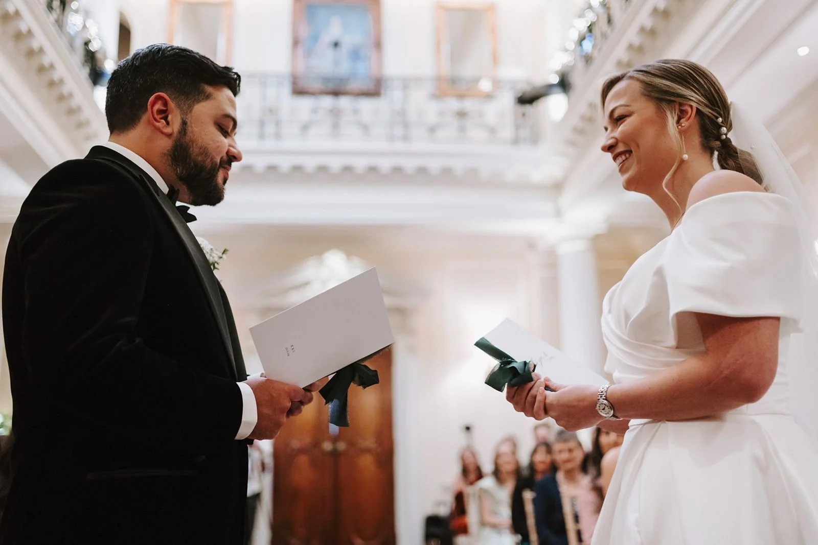 Bride smiling at groom delivering his personal vows