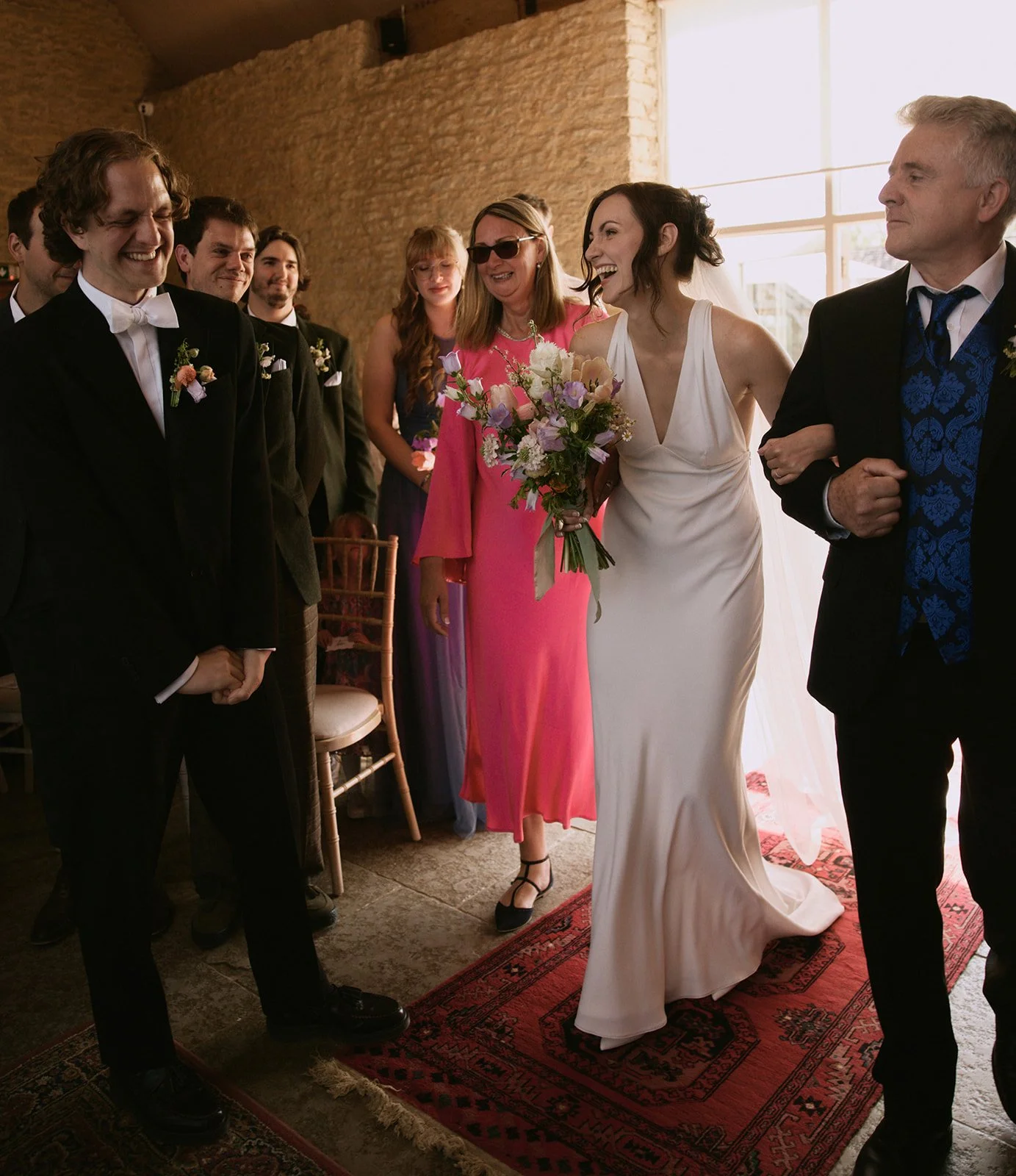 Bride entering ceremony laughing and relaxed