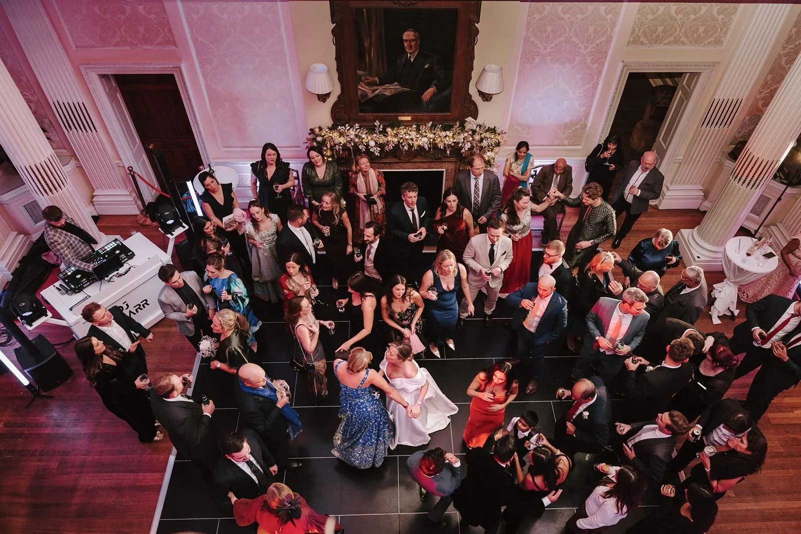 Wedding guests dancing to DJ on dancfloor at Hedsor House