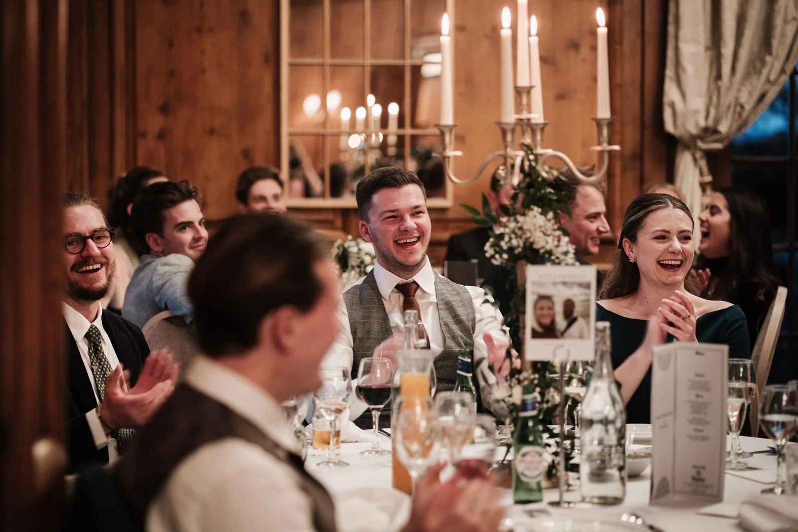 Wedding guests laughing during wedding speeches