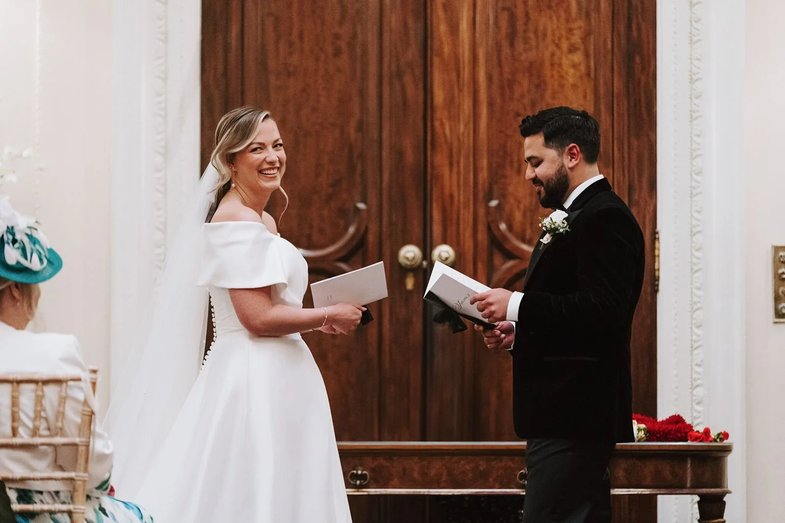 Bride and groom holding vow booklets delivering personal vows