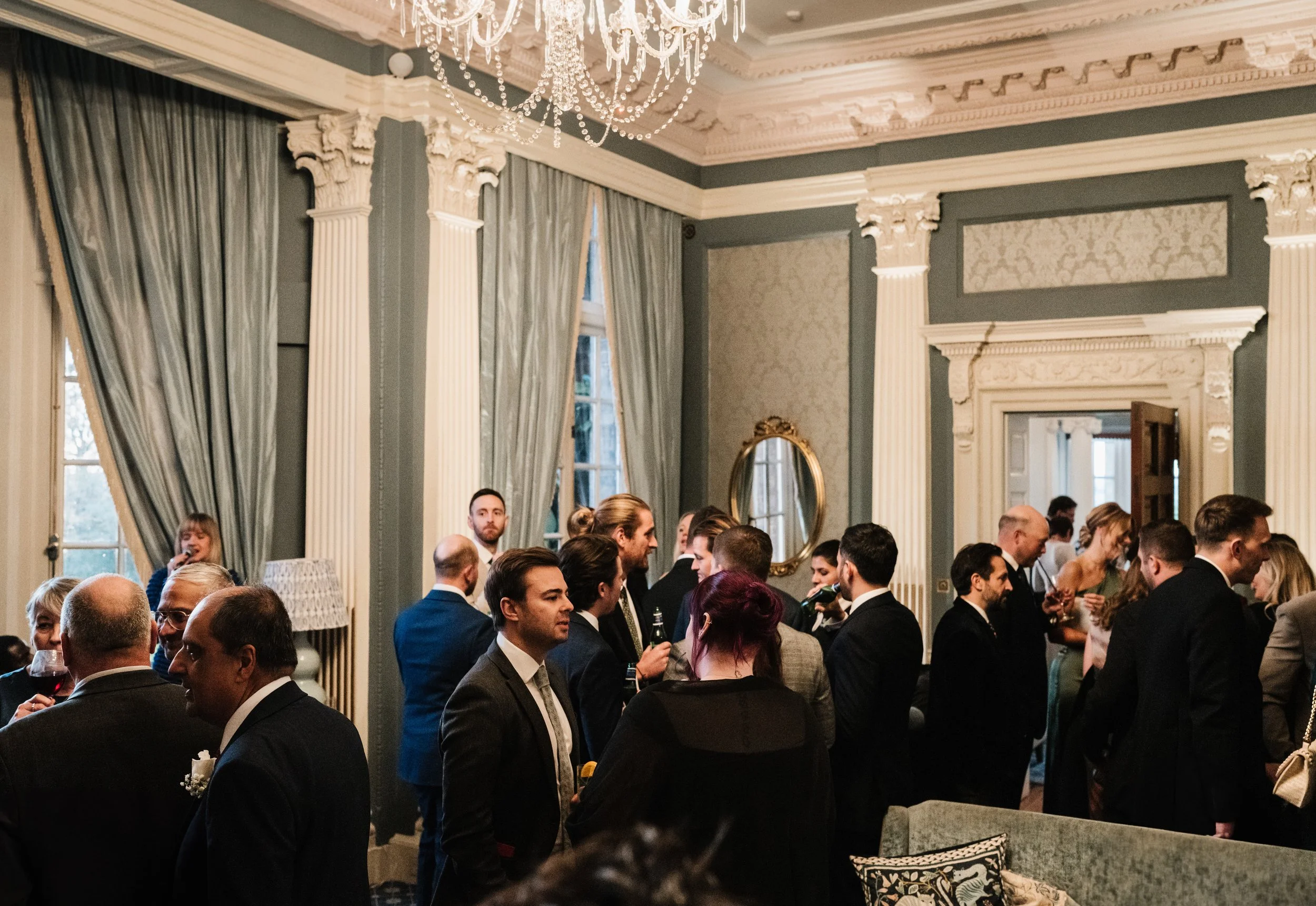 Wedding guests enjoying drinks reception with live music and singer