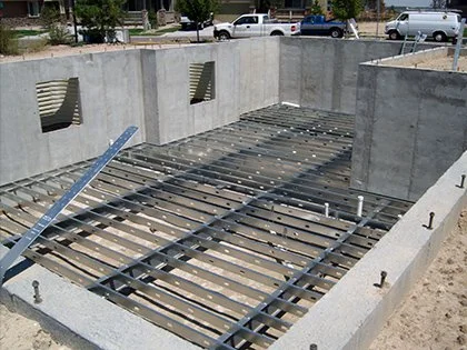 Open foundation of a Colorado home showing steel joists for a structural floor