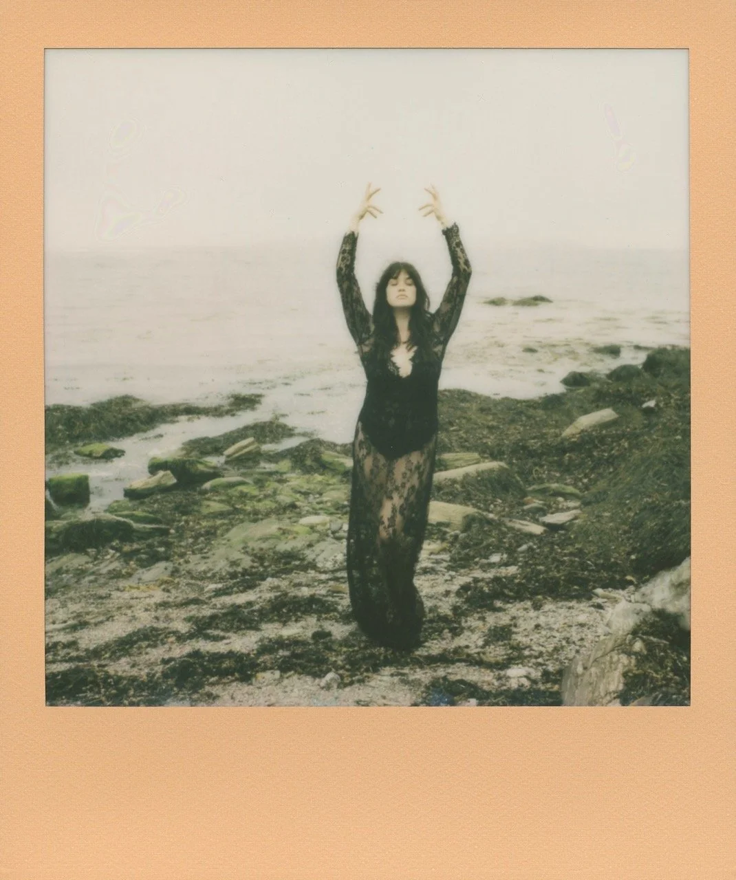 Woman posing elegantly by the oceanside