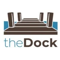 Logo of a dock with wooden planks and posts, with the text 'the Dock' underneath.