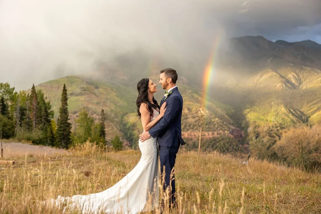 Bride and groom with a rainbow at San Sophia Overlook