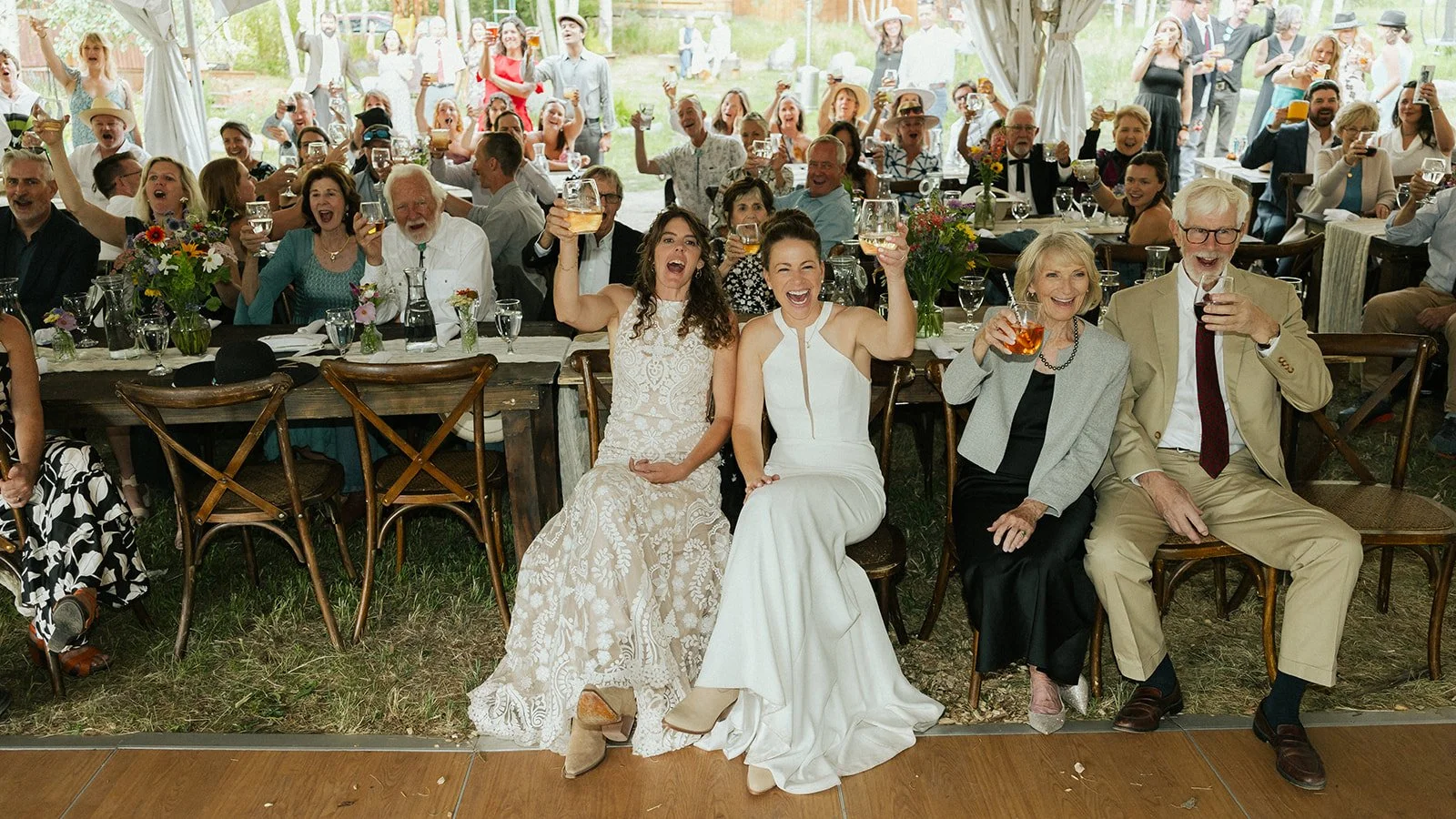 Brides and parents toasting
