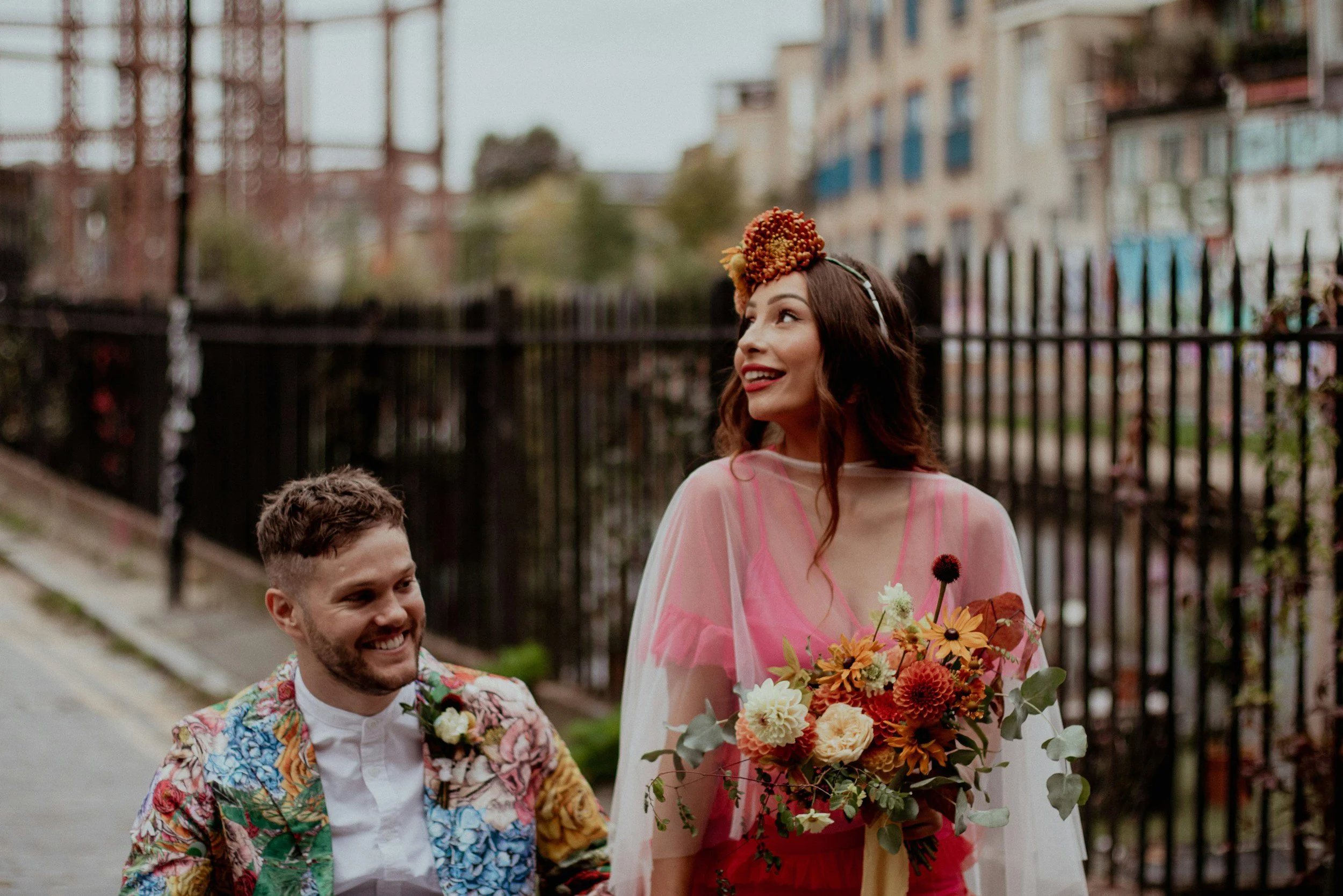 couple in colourful wedding clothes and bright flowers