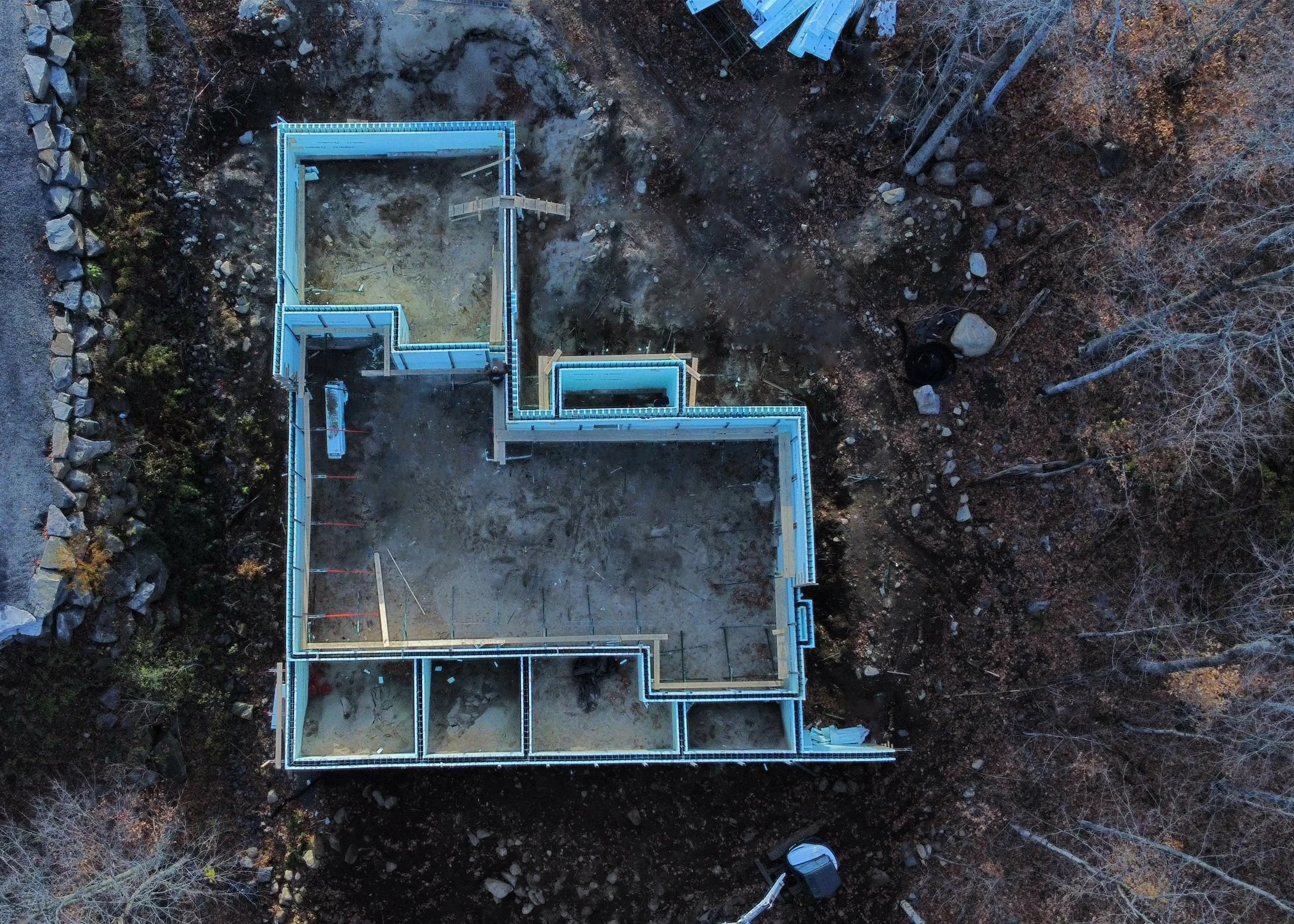 Drone view of an ICF foundation layout on a rocky Muskoka site