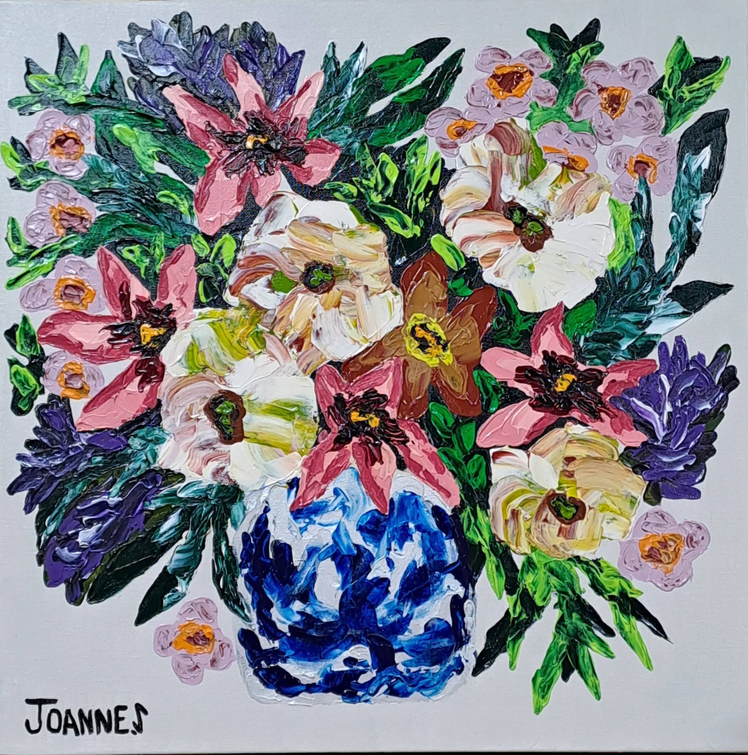 A colorful painting of a flower bouquet featuring purple, blue, white, and yellow flowers with green leaves on a gray background, signed by Joanne.