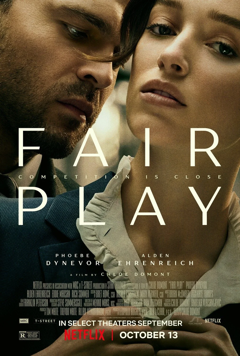 Close-up of a man and woman with serious expressions on their faces, promoting the movie "Fair Play." The text on the poster reads, "Fair Play, Competition is Close," with the release date October 13 and that it is available on Netflix.
