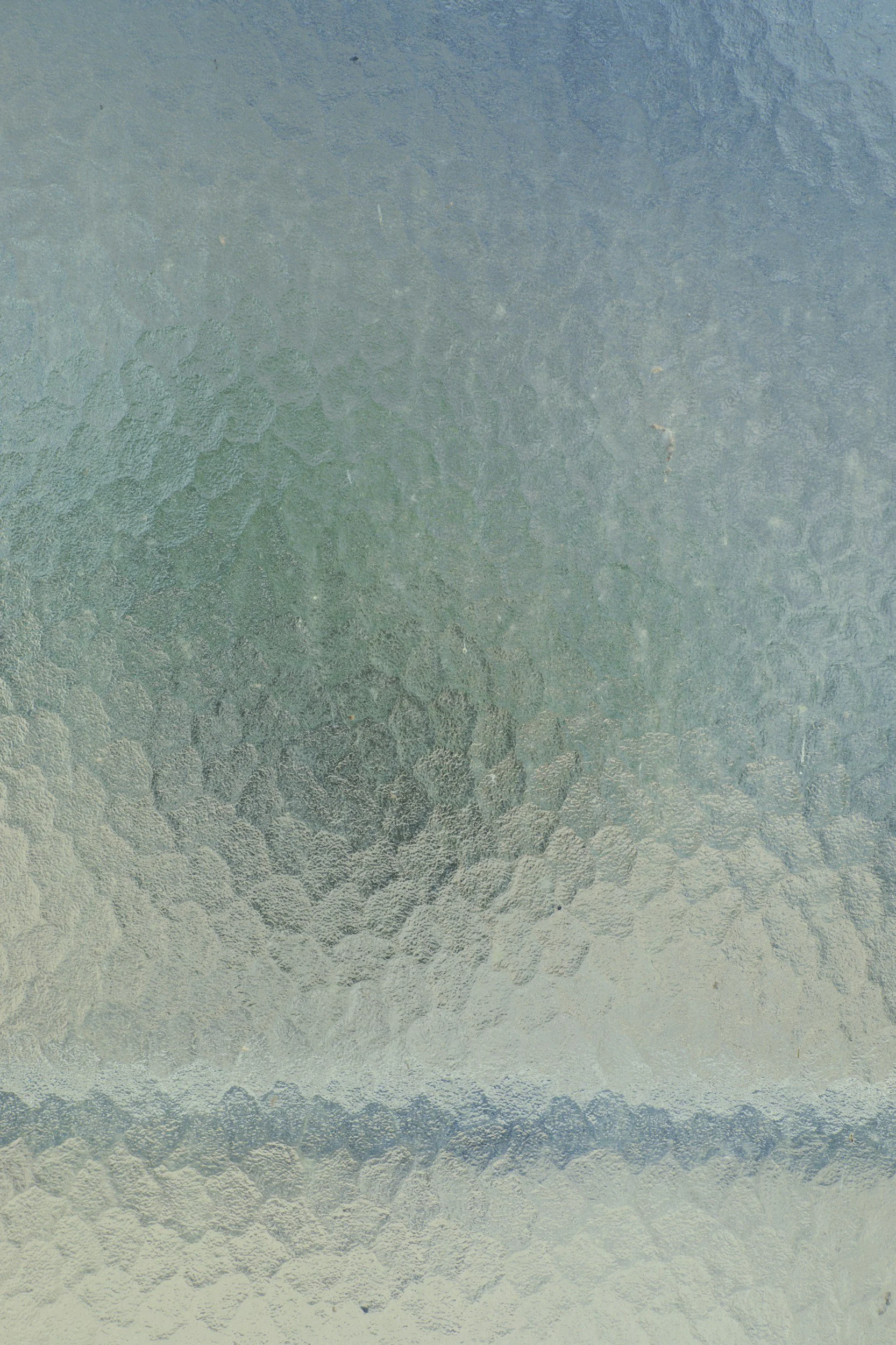 Frosted glass window with textured, icy surface