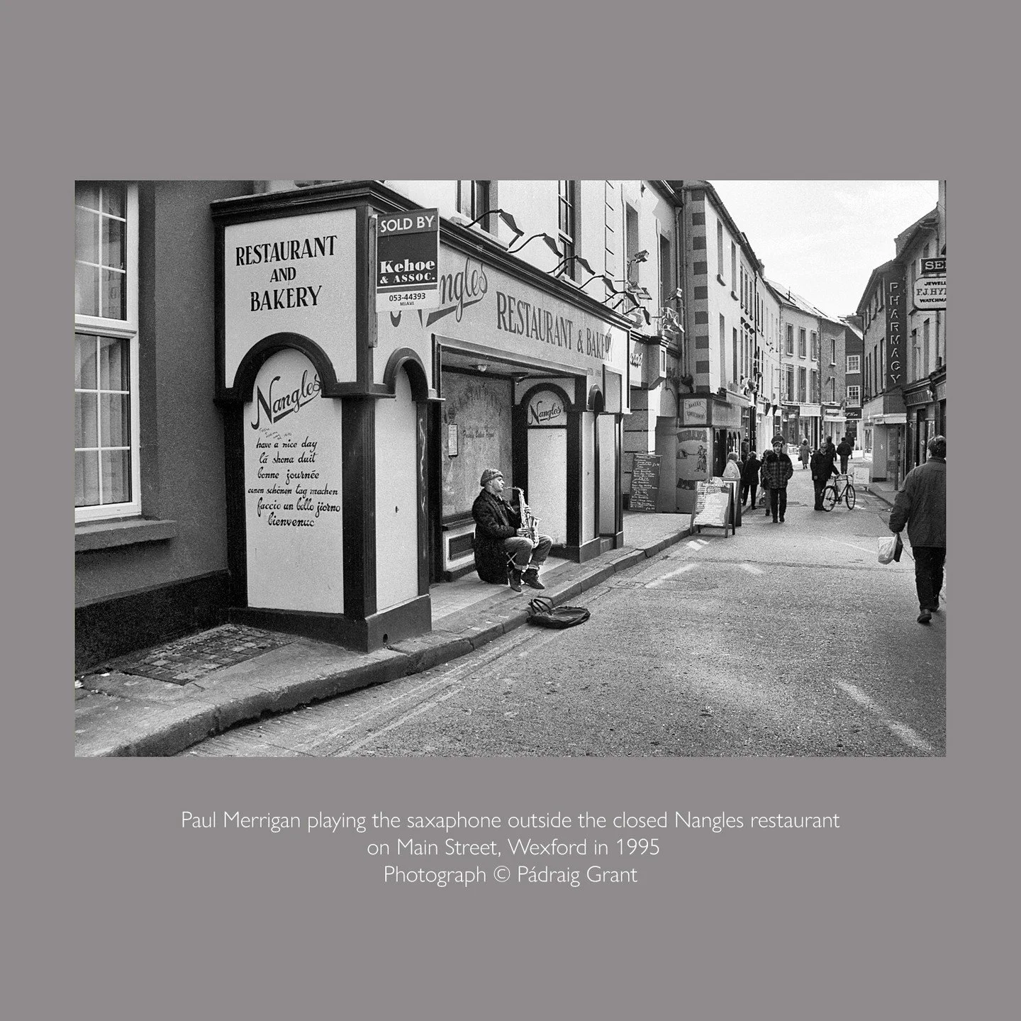 Paul Merrigan playing the saxaphone outside the closed Nangles restaurant on Main Street, Wexford in 1995

Photograph &copy; P&aacute;draig Grant
#padraiggrantswexford