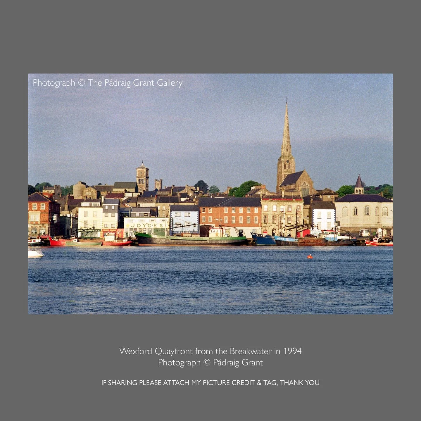 Wexford Quayfront from the Breakwater 
1994

If sharing please attach my photo credit &amp; tag:
 Photograph &copy; P&aacute;draig Grant

Featuring mussel dredgers and quayfront businesses: Sidetracks, The Chuck Wagon, Joyce's, Dixie's Pub and South 