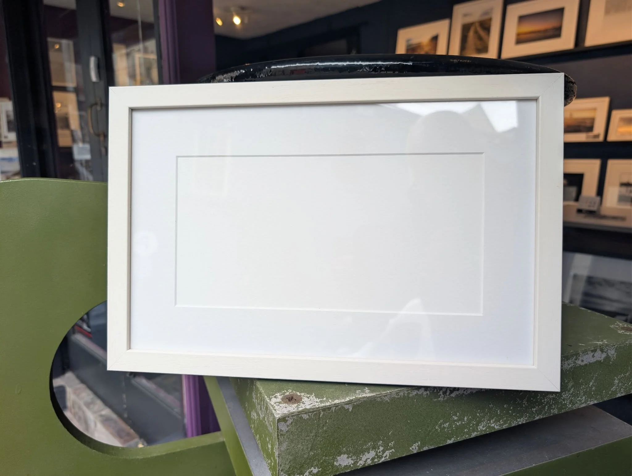 I don't photograph in the ratio shown in the pictured frame below.

Therefore,  I have a surplus of 32 off-white, wooden, 38cm x 25cm (15" x 9.5") size frames available. Each comes with glass and cut mount and hangers....the cut mount size 