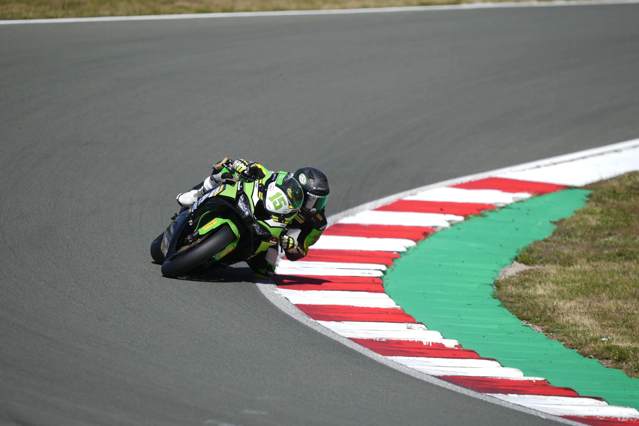 black and green kawasaki leaning into a corner in Grobnik circuit in the sun zx6r