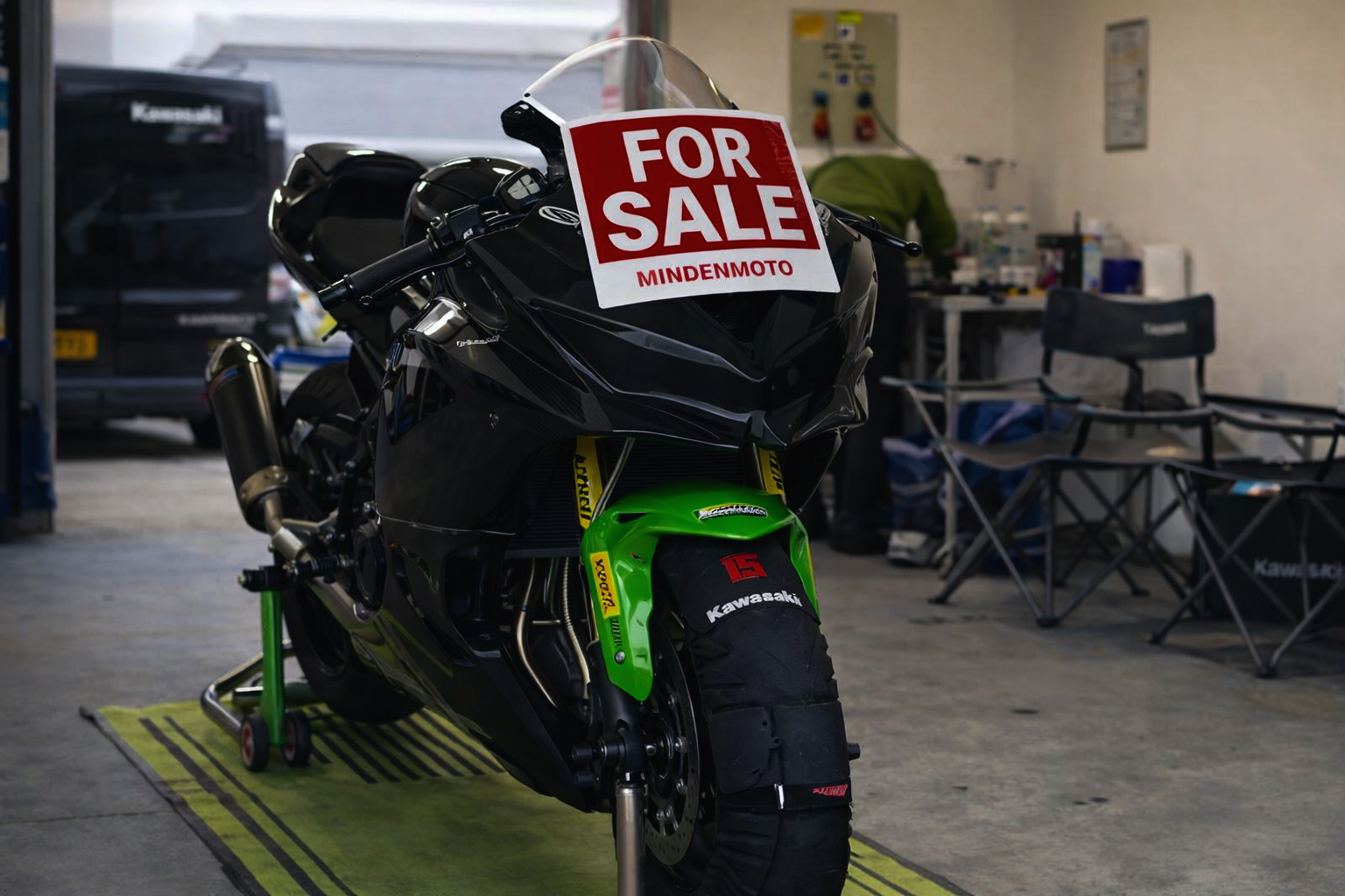 black kawasaki zx4rr with for sale sign on the nose of the bike 