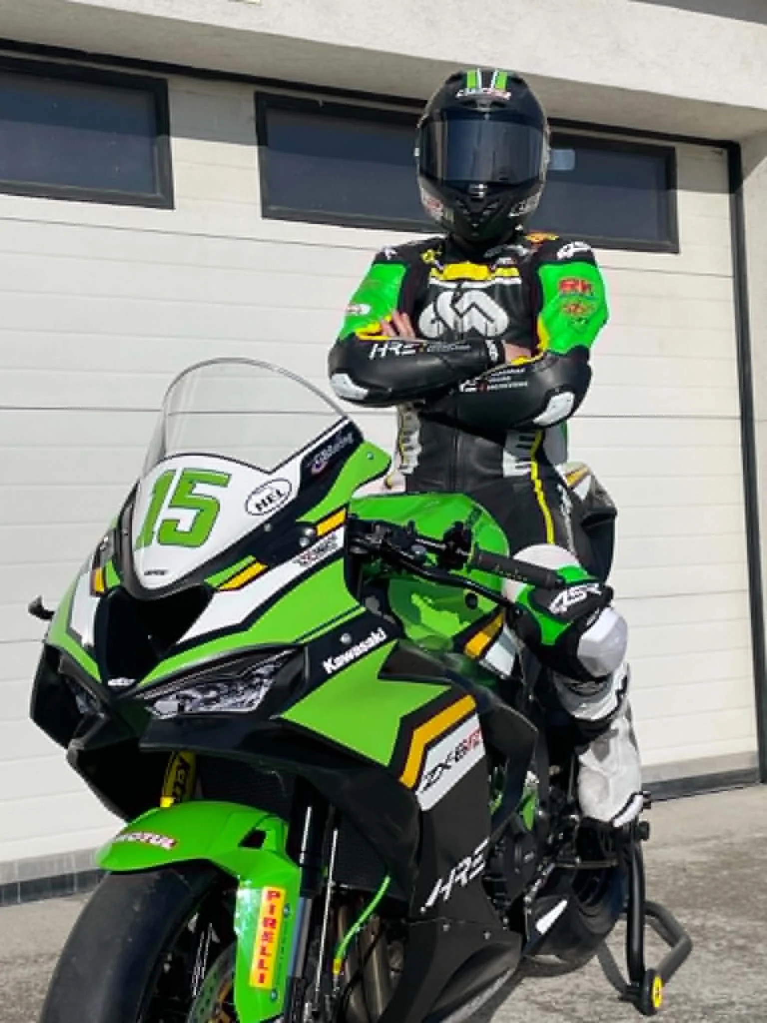 Luki Owen in race leathers with his number 15 Kawasaki motorcycle