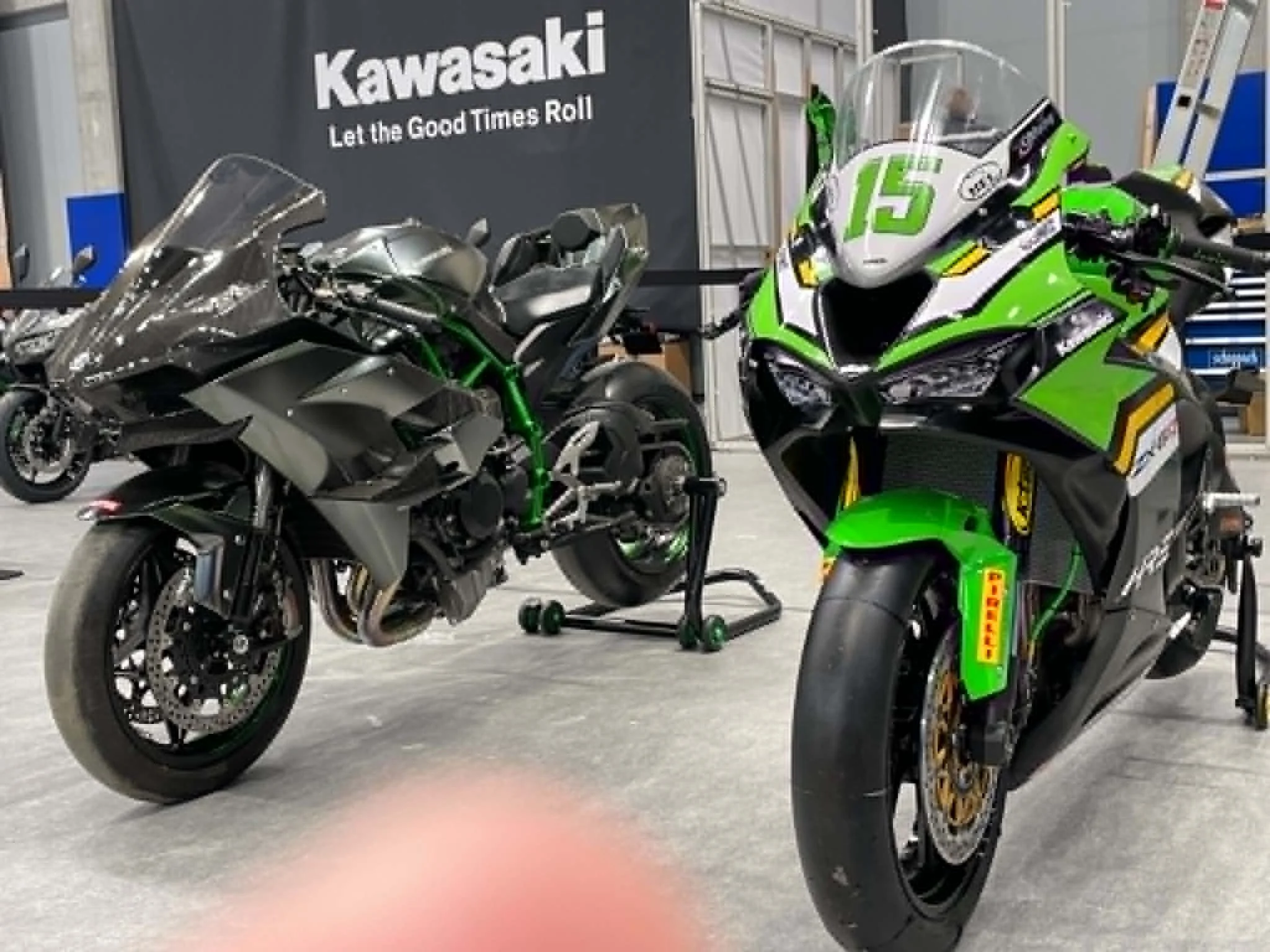 Minden Moto Kawasaki race motorcycles displayed beneath the Kawasaki banner