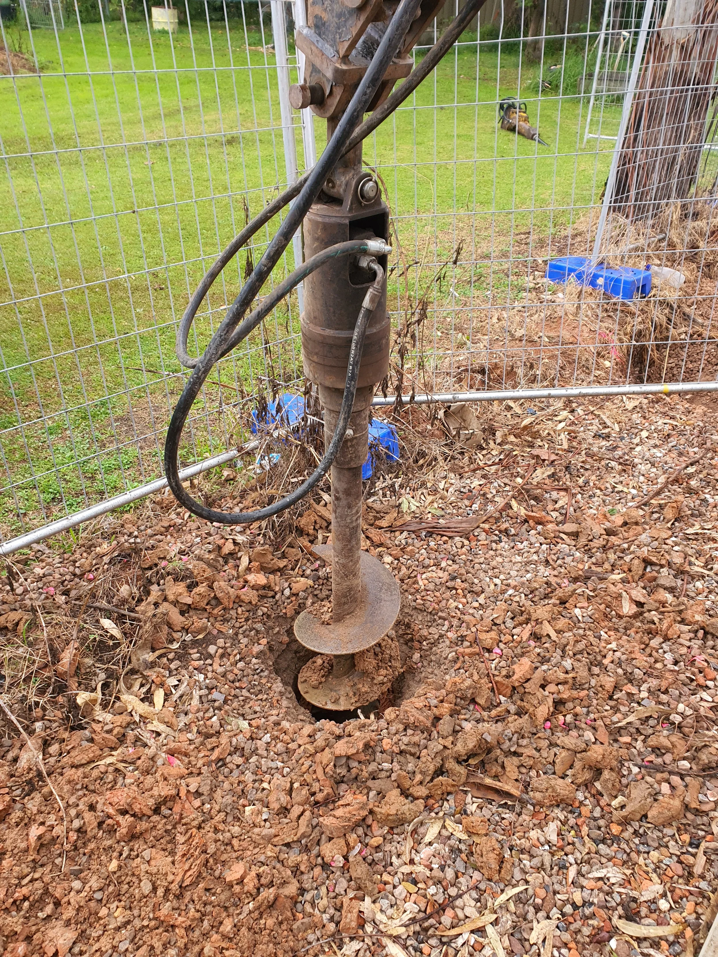 excavator using auger drilling in soil for foundations and footings in Sydney.