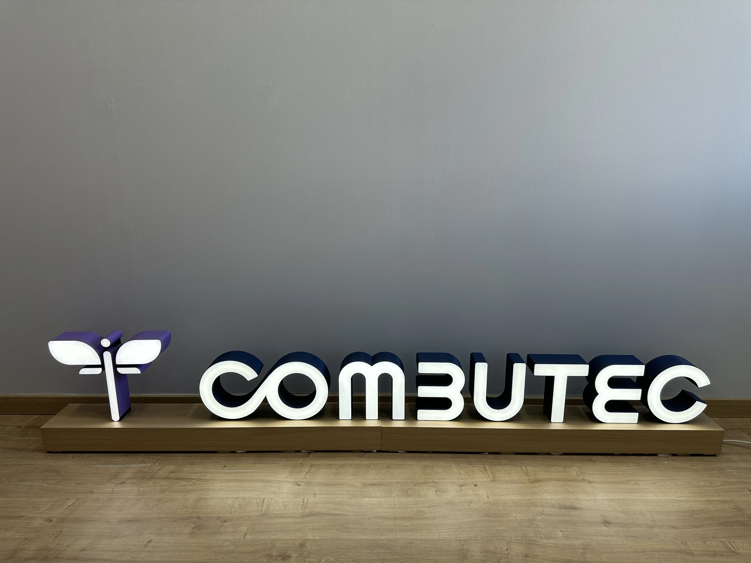 Logo para COMBUTEC iluminado de dos metros y medio de longitud diseñado desde cero, impreso en filamento multicolor, electrificado con LED y montado con un sistema de encaje central.