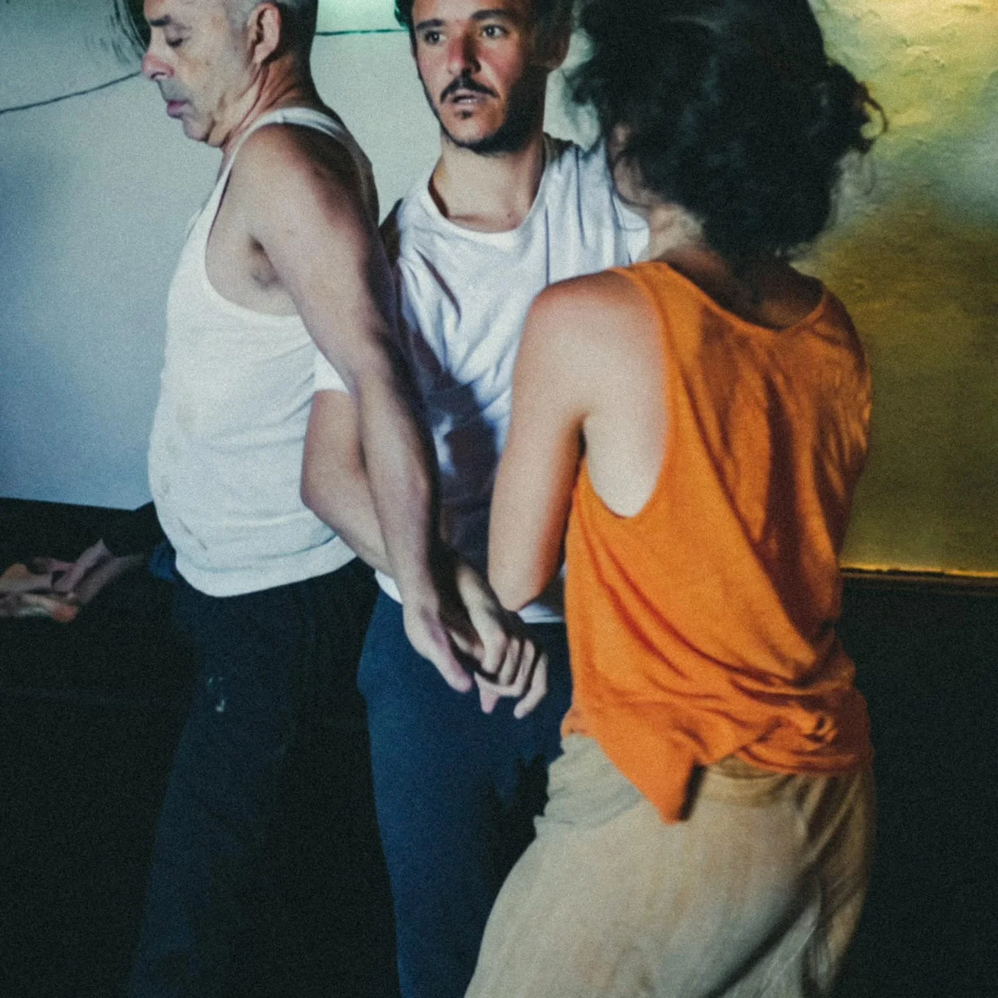 Pedro dancing contact improvisation with partners, showing somatic awareness and embodied connection