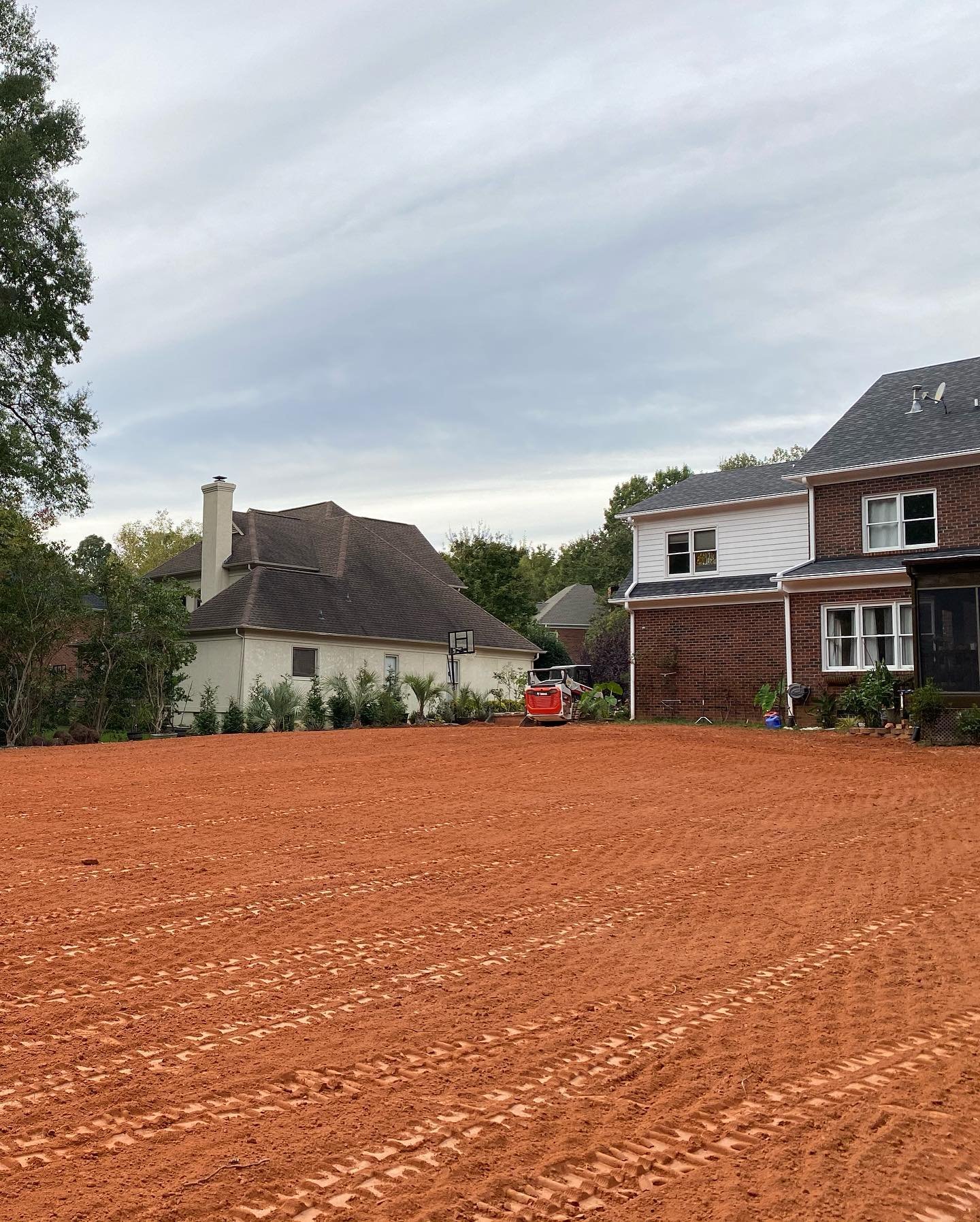 Customer had a steep slope in the backyard so we hauled in 60 loads of dirt, graded and Harley raked it👌  Call us for a free estimate! (704) 221-7101