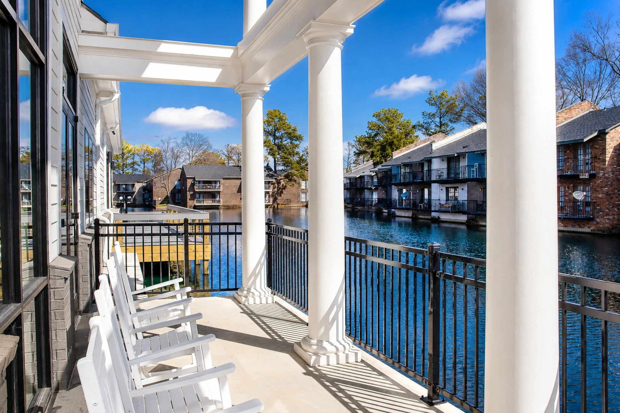 Adirondack chairs over looking lake.