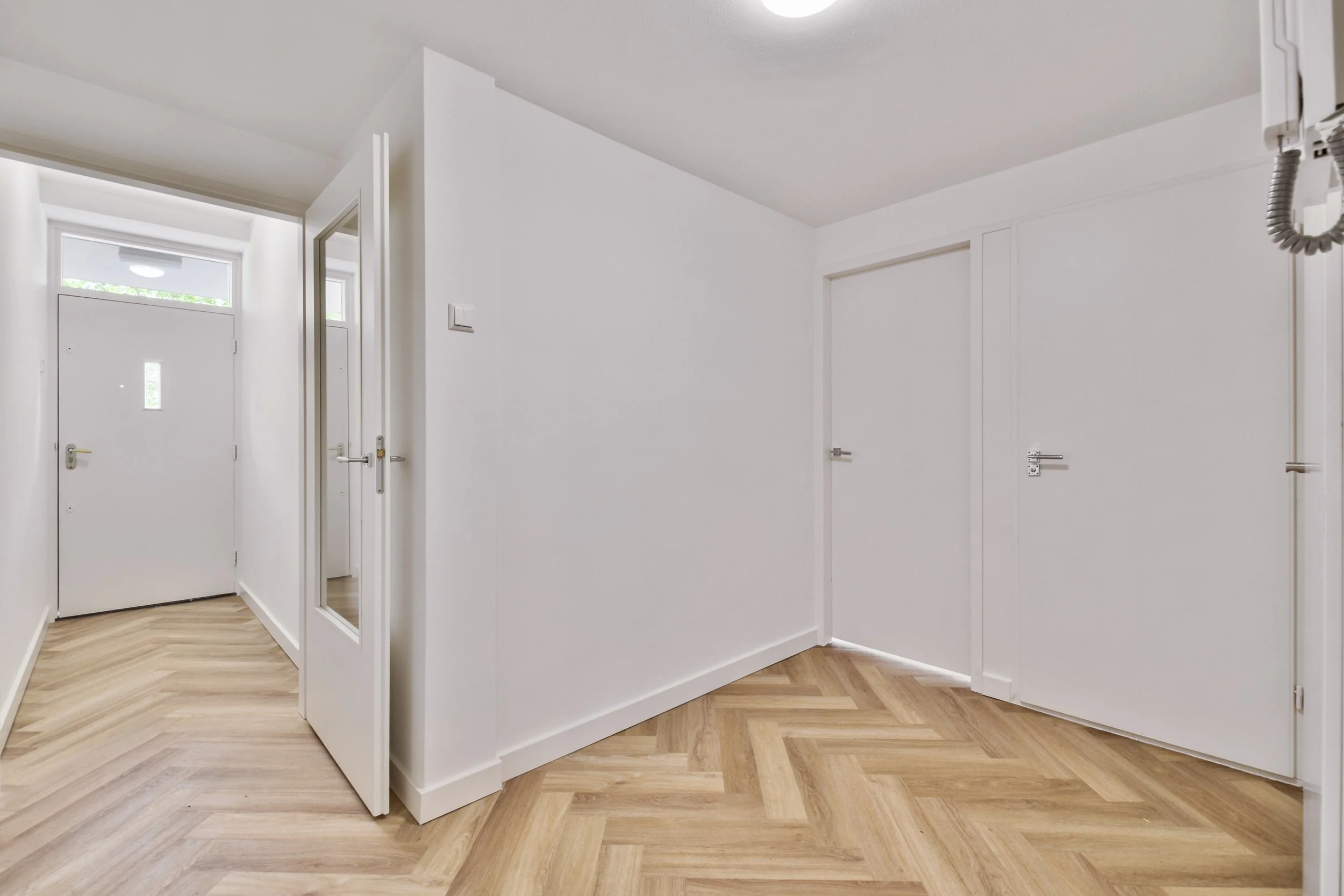 empty-interior-area-with-white-walls-laminate-flooring.jpg