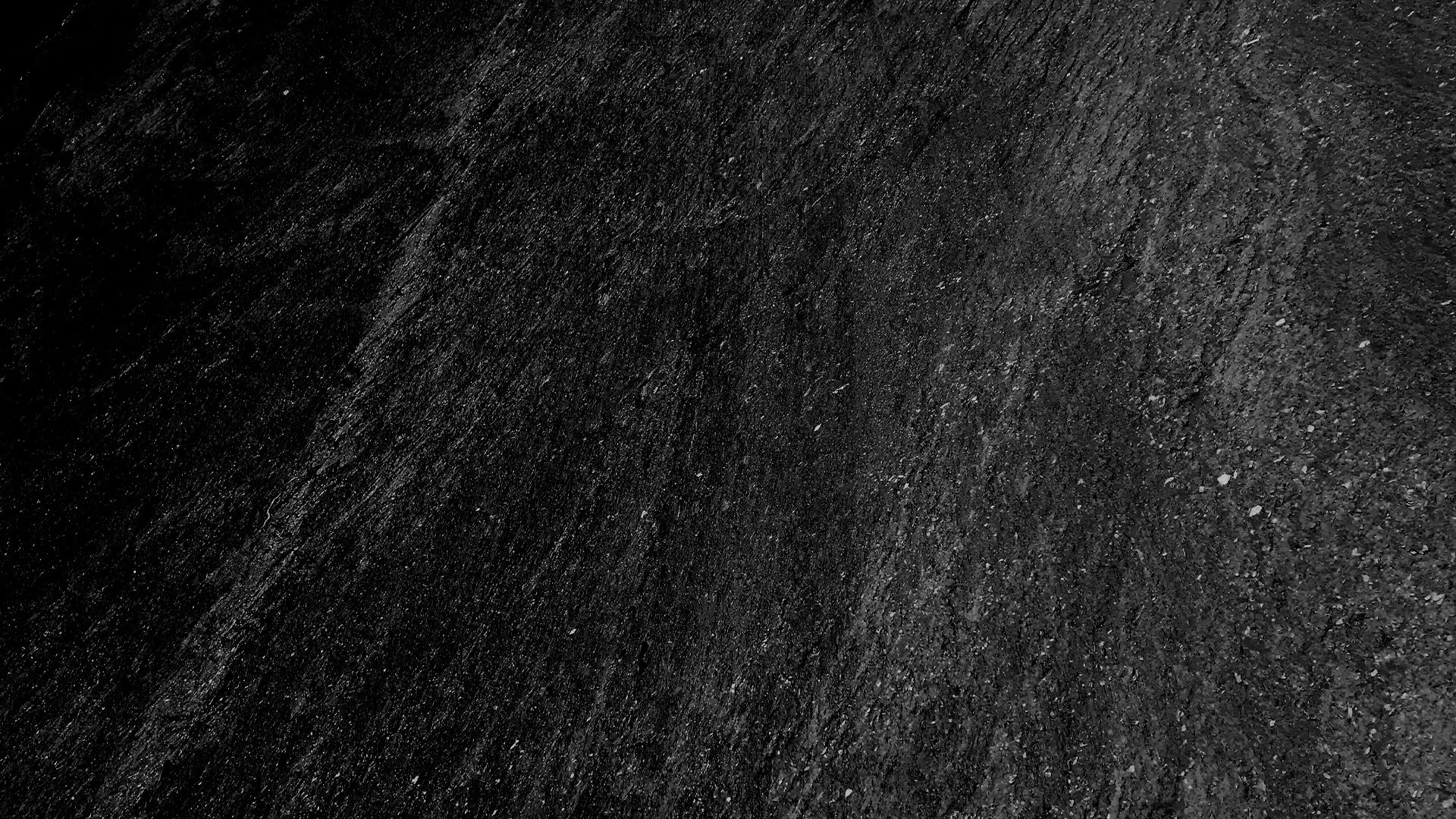 Close-up image of black asphalt pavement surface.