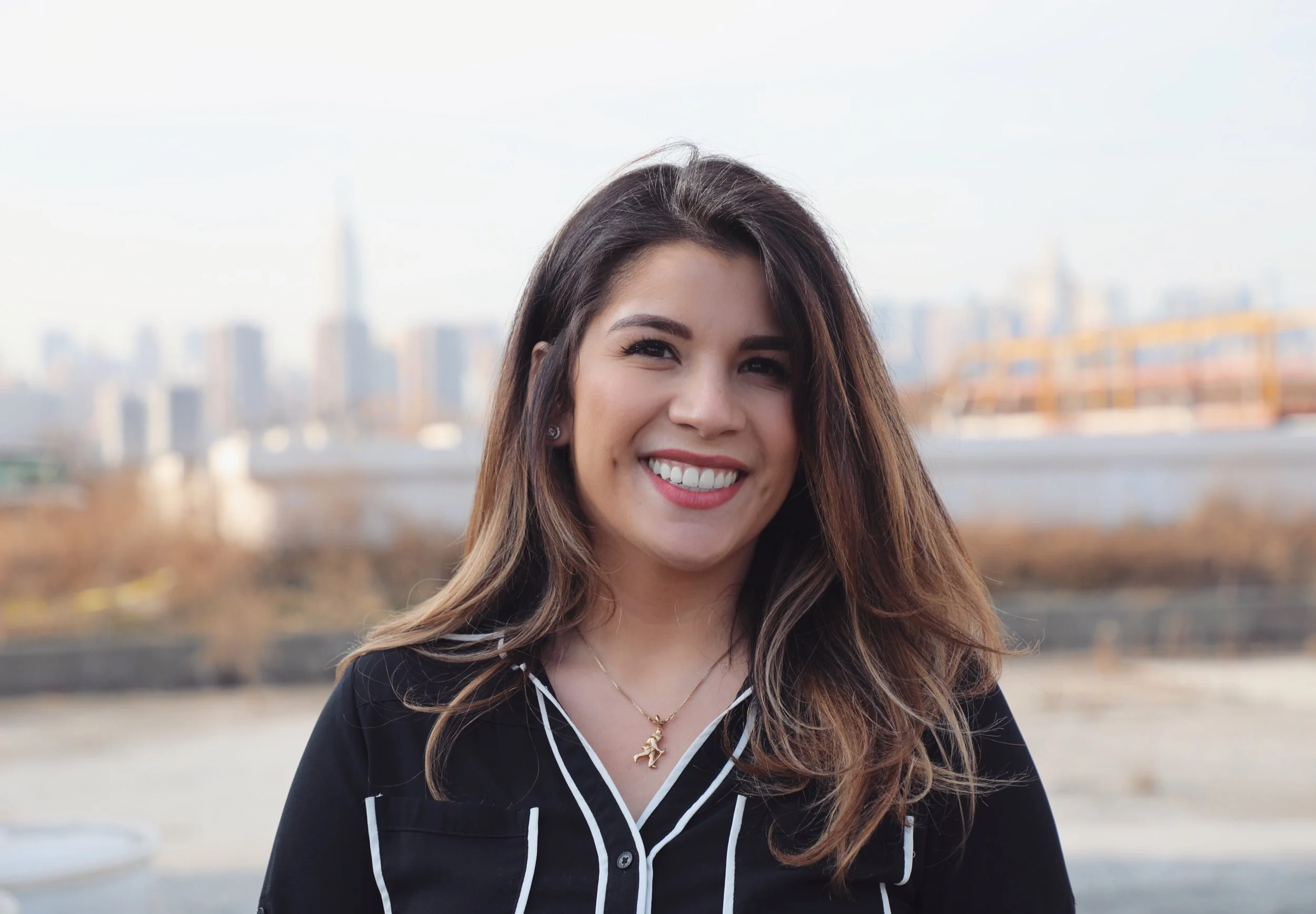 Portrait of therapist Alessandra Avallone with New York City skyline in the background