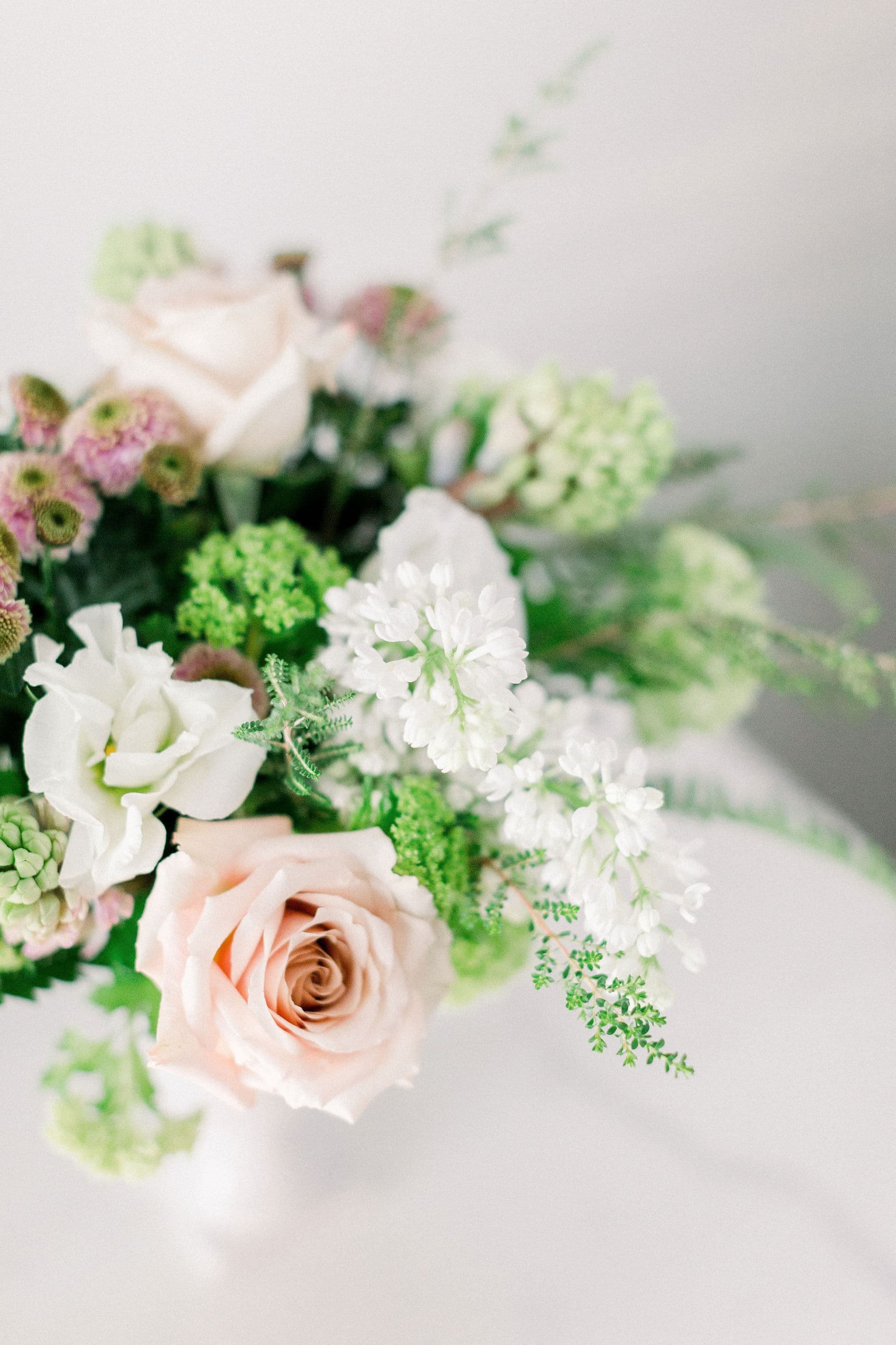 A beautiful floral arrangement with white and pink flowers, designed by Twig & Bloom Regina.