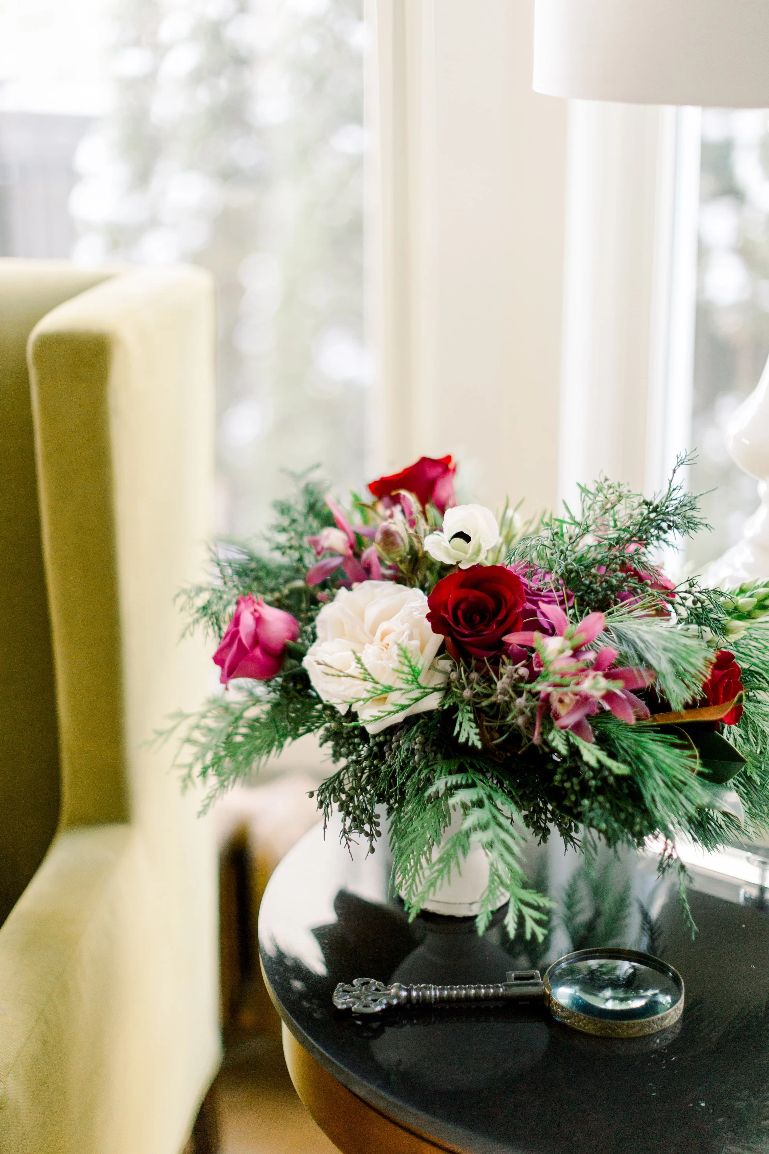 A holiday floral arrangement with jewel tone blooms. 