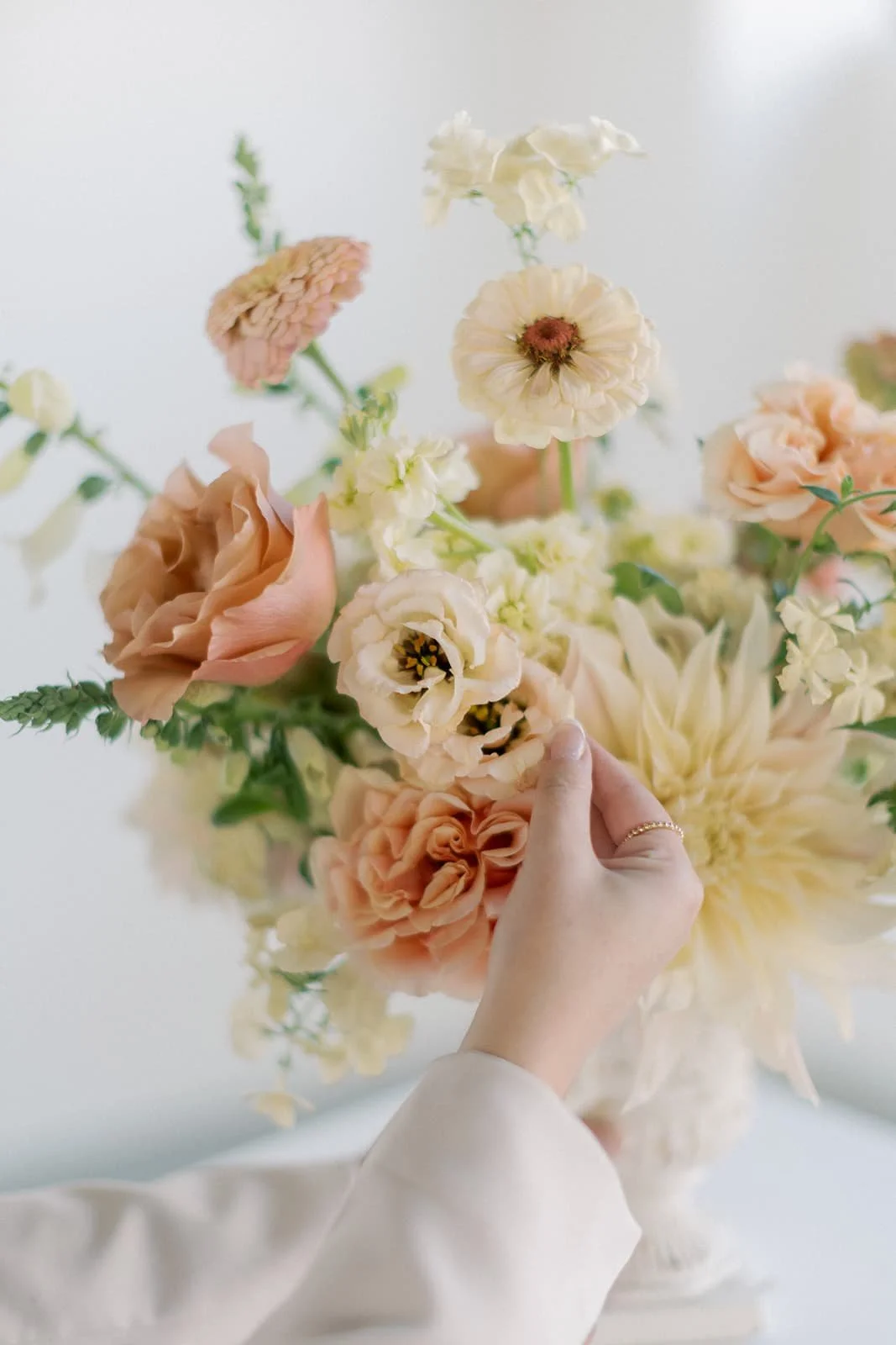A Twig & Bloom Regina wedding bouquet designed with peach and soft yellow flowers.