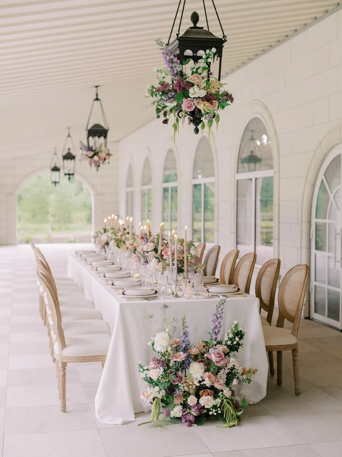 A wedding head table decorated with Twig & Bloom  centrepieces and floral arrangements.