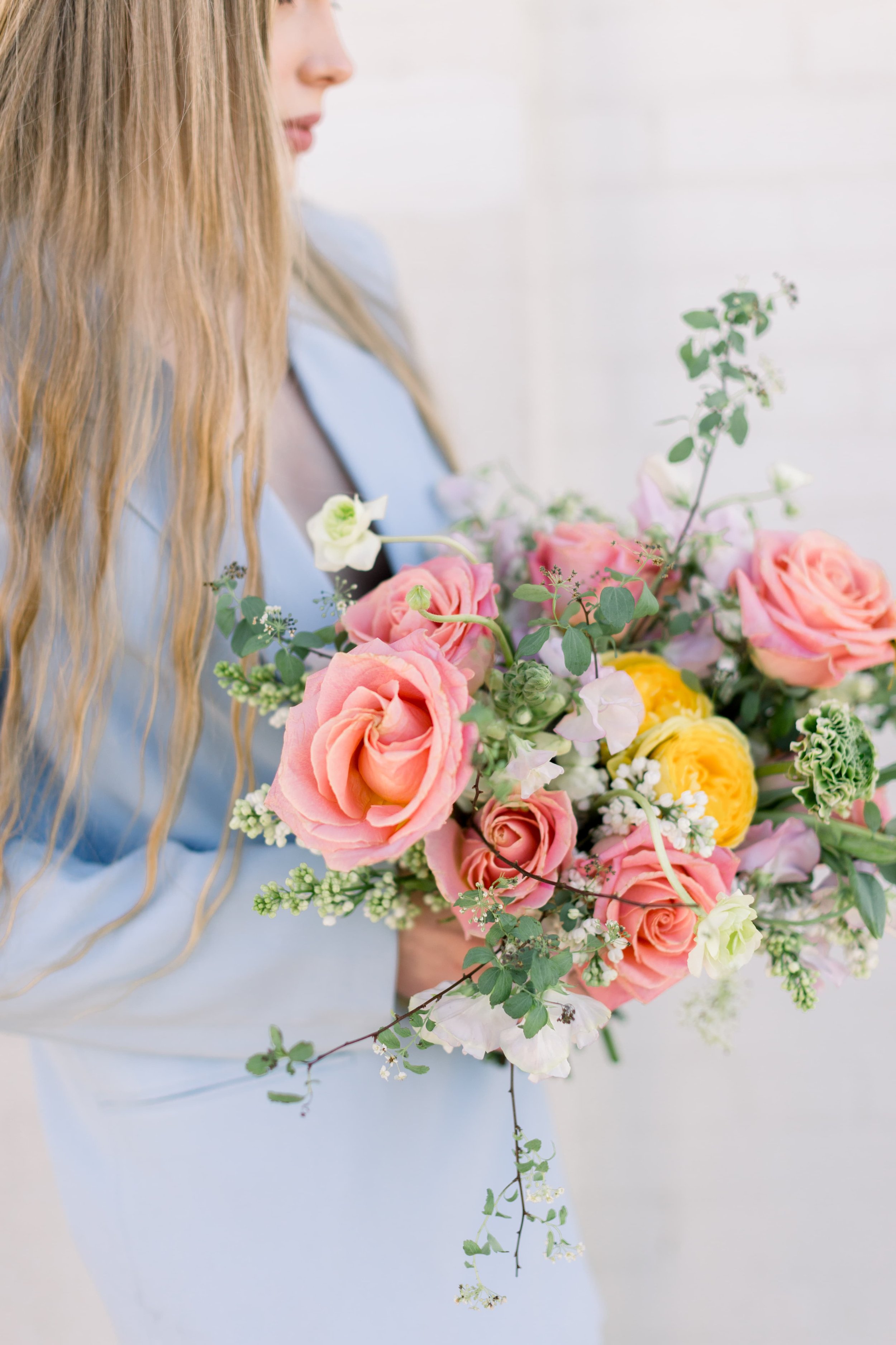 A spring bouquet made with pink and yellow flowers, designed by Twig & Bloom in Regina Sk.