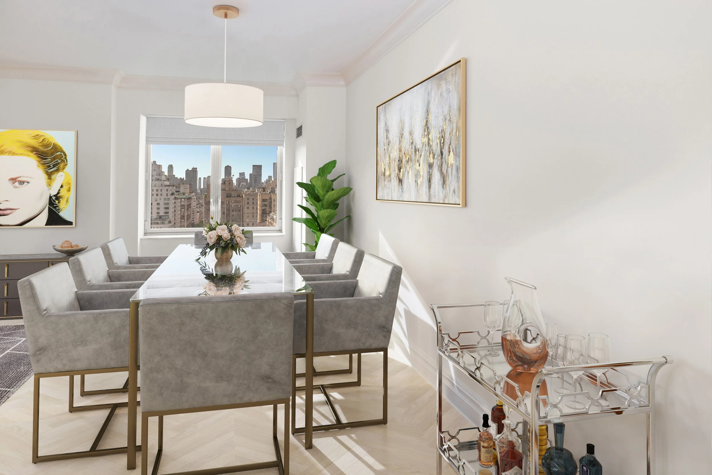 Modern dining room with a large white dining table, eight gray upholstered chairs, a centerpiece flower arrangement, large window with city view, white walls with artwork, a tall green plant, and a metal bar cart with glassware and bottles.