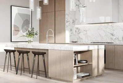 Modern kitchen with a white marble island, three barstools, a potted plant, and minimalist cabinetry.