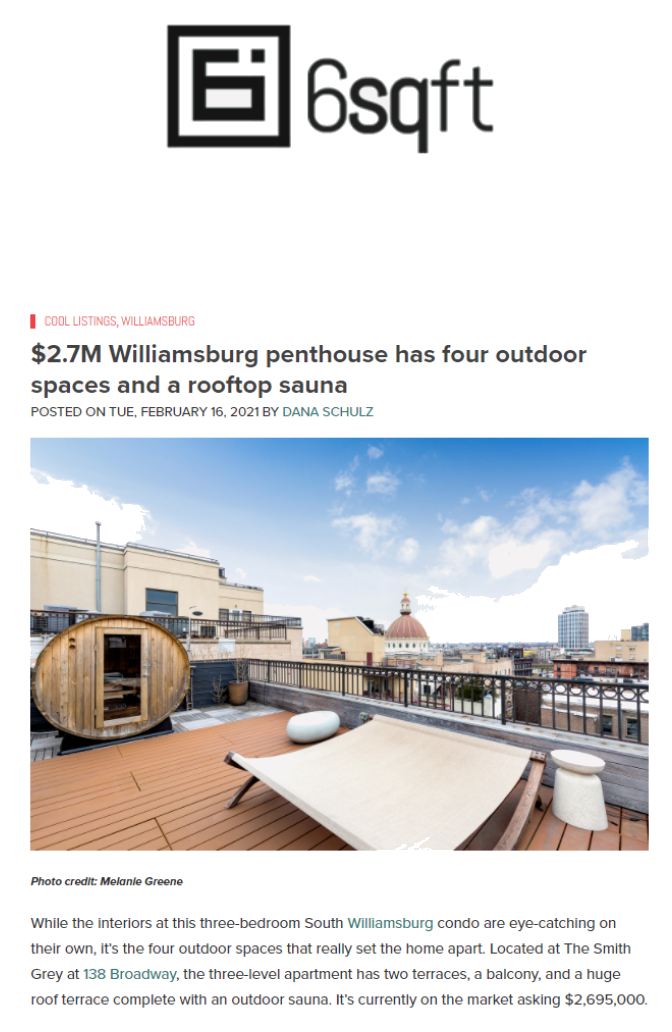Photo of a rooftop terrace with outdoor furniture, a barrel-shaped sauna, city skyline, and blue sky with clouds.